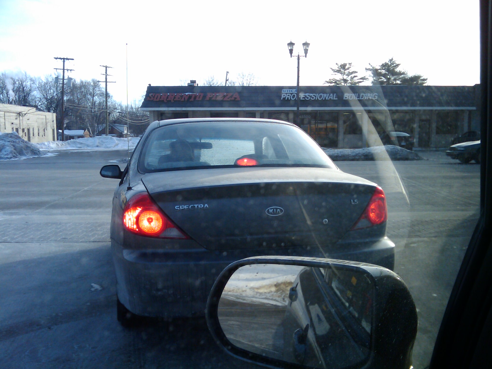 This person, turning left in front of me, hadn't bothered to clear off most of her car's windshield.