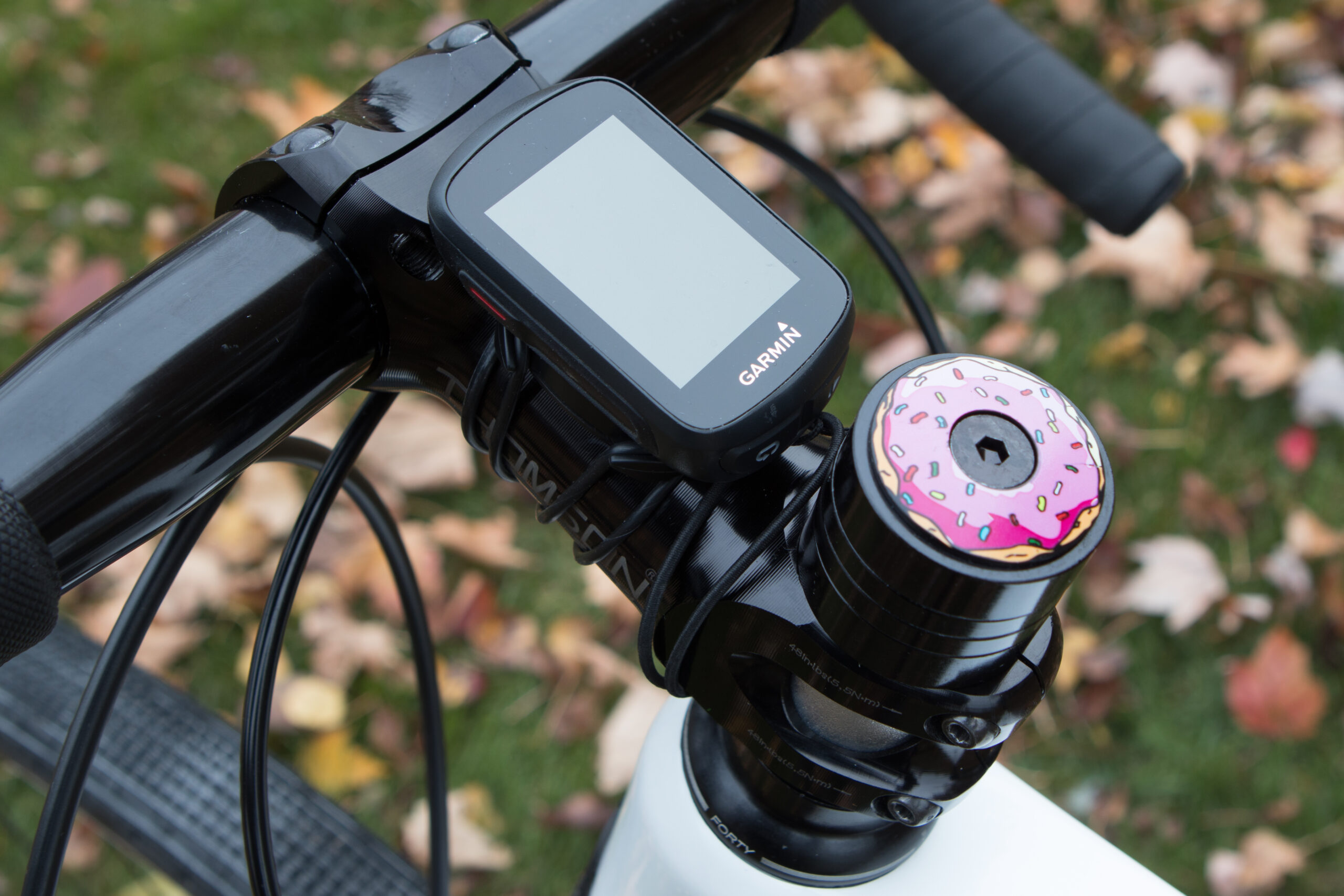 Stem area, including the Garmin Edge 130 and MASH Donut 2.0 top cap.