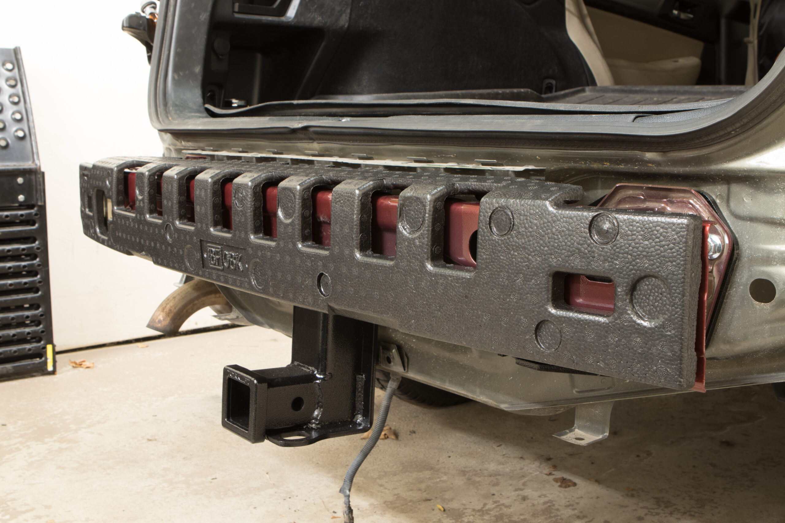 Foam cushion over the bumper beam, and hitch installed.