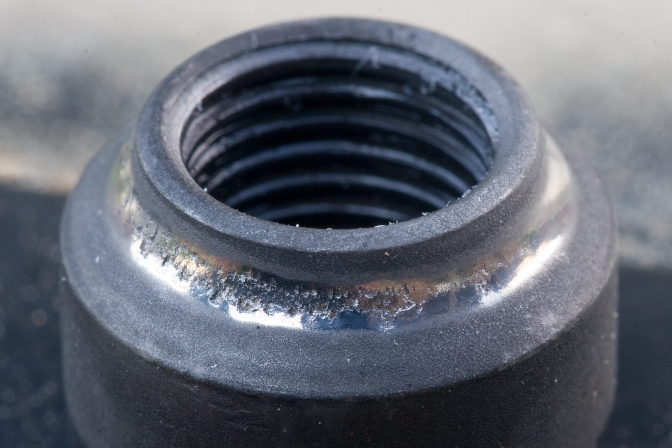 Wear in the bearing race on one of the cones on the front wheel of my bike. This explains the poor rolling. I think it's time for new wheels.