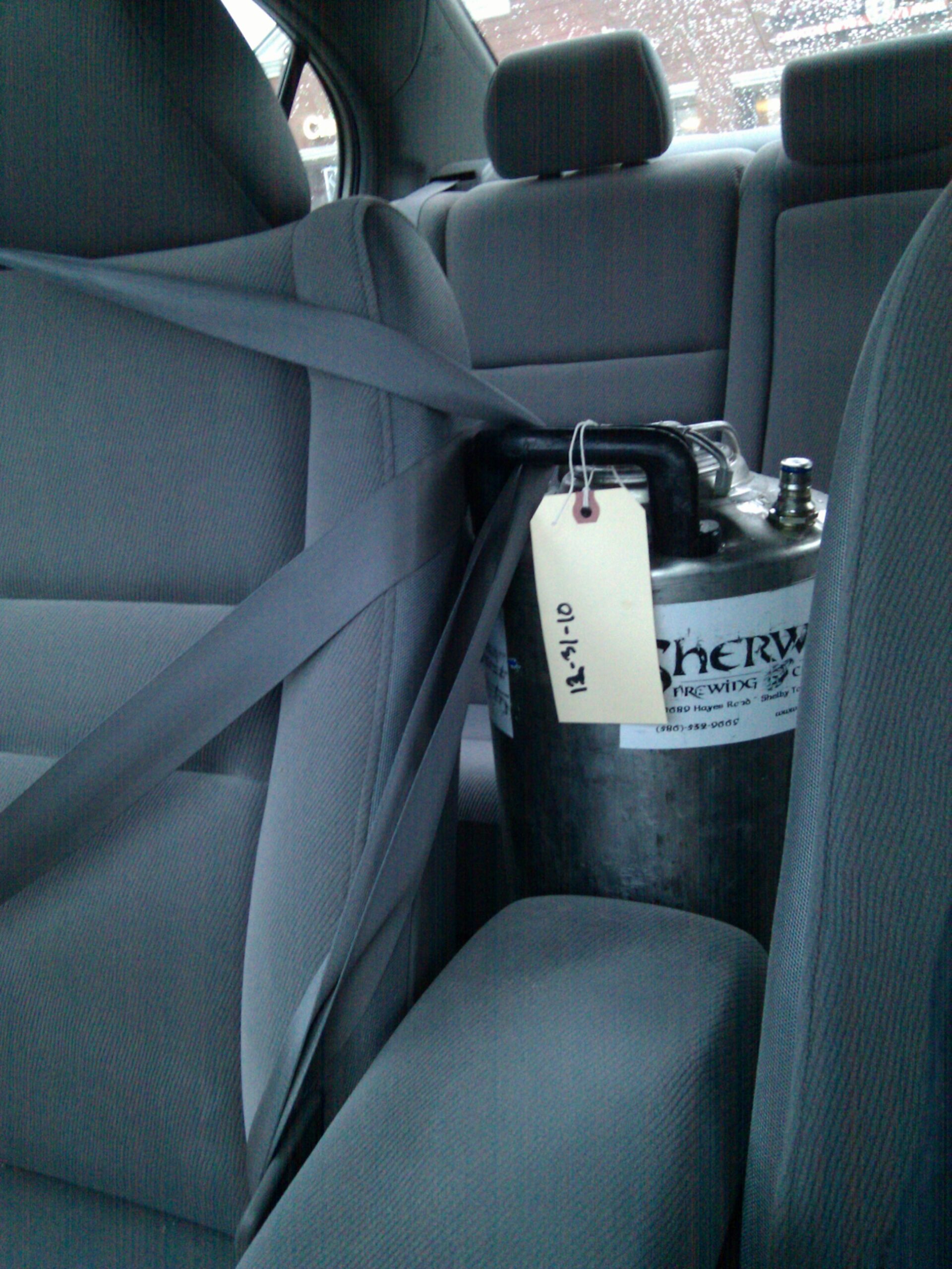 The automatic lock on full seatbelt extension (for child seats) has finally proven useful for holding a keg of beer in place. This is five gallons of Salonius Pale Ale from Sherwood Brewing Company.
