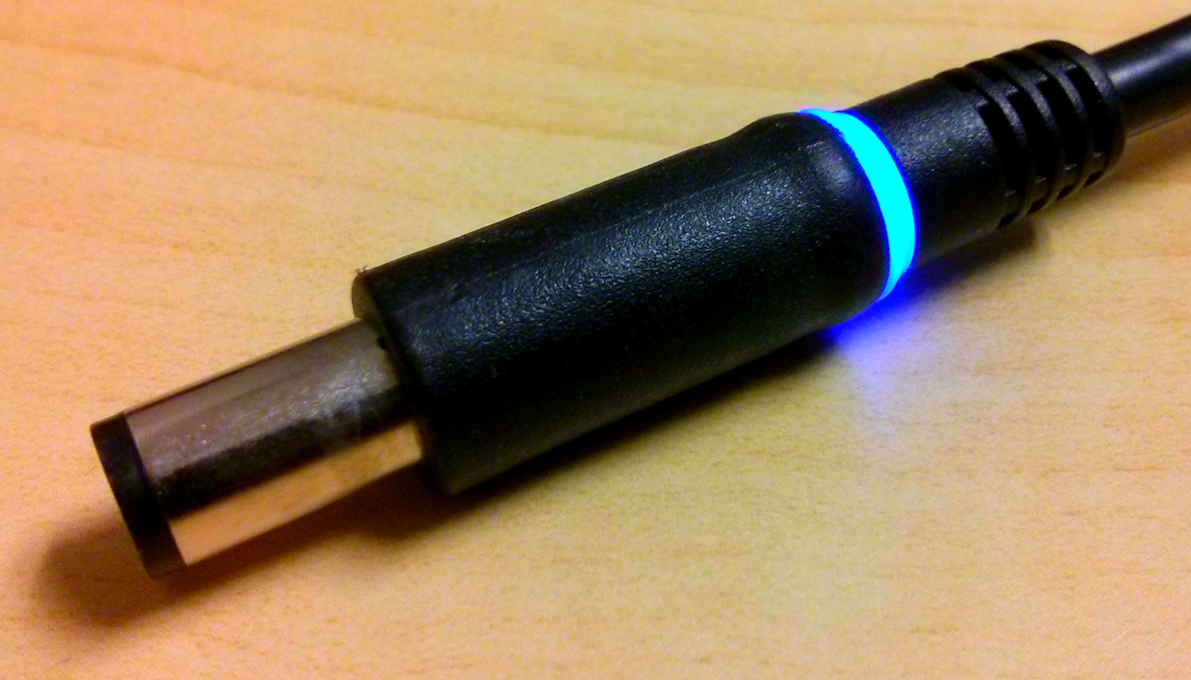 Dell laptop power supply connector with blue LEDs.