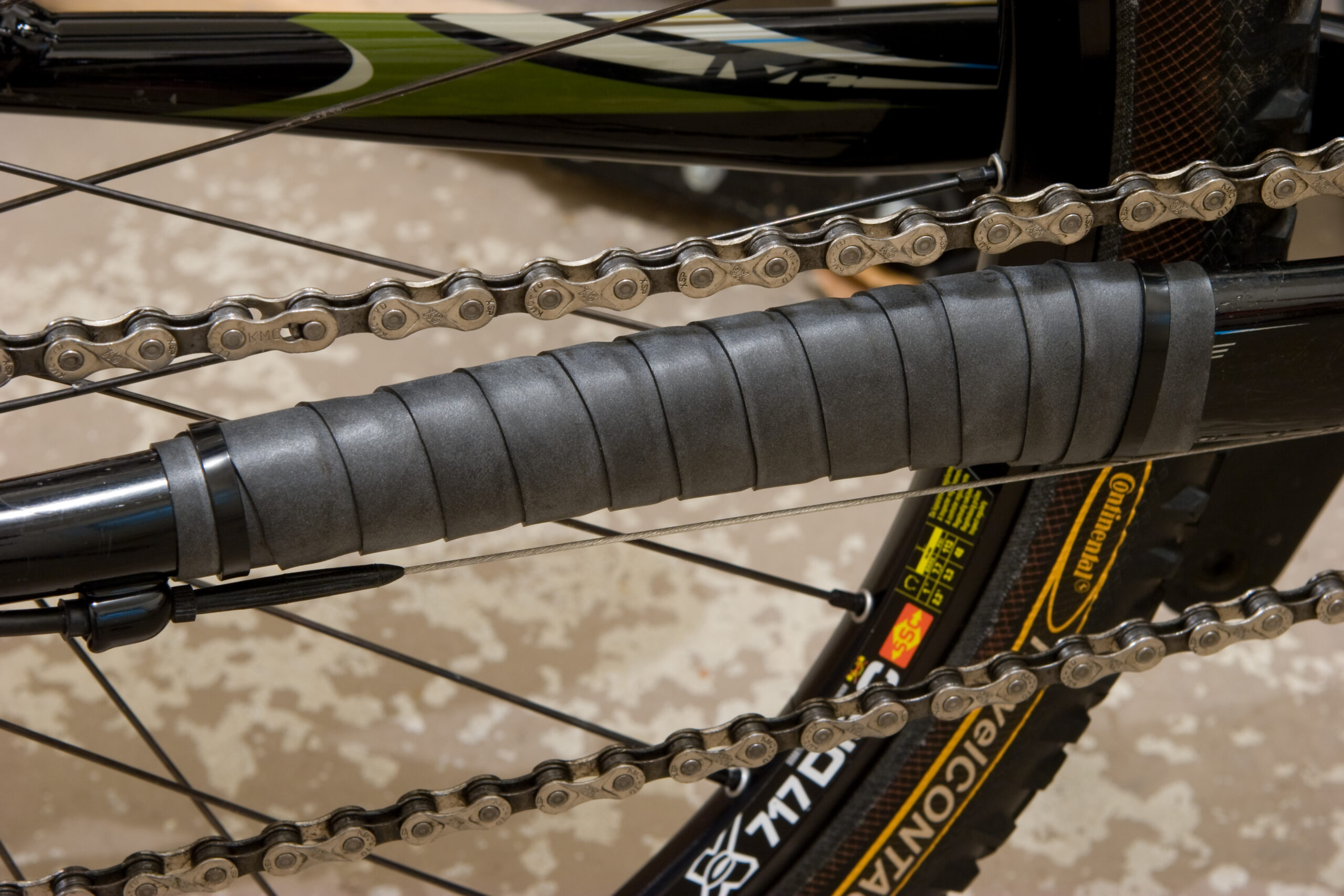 An old tube cut into a 1" strip and wrapped around the chainstay to quiet down chain slap.