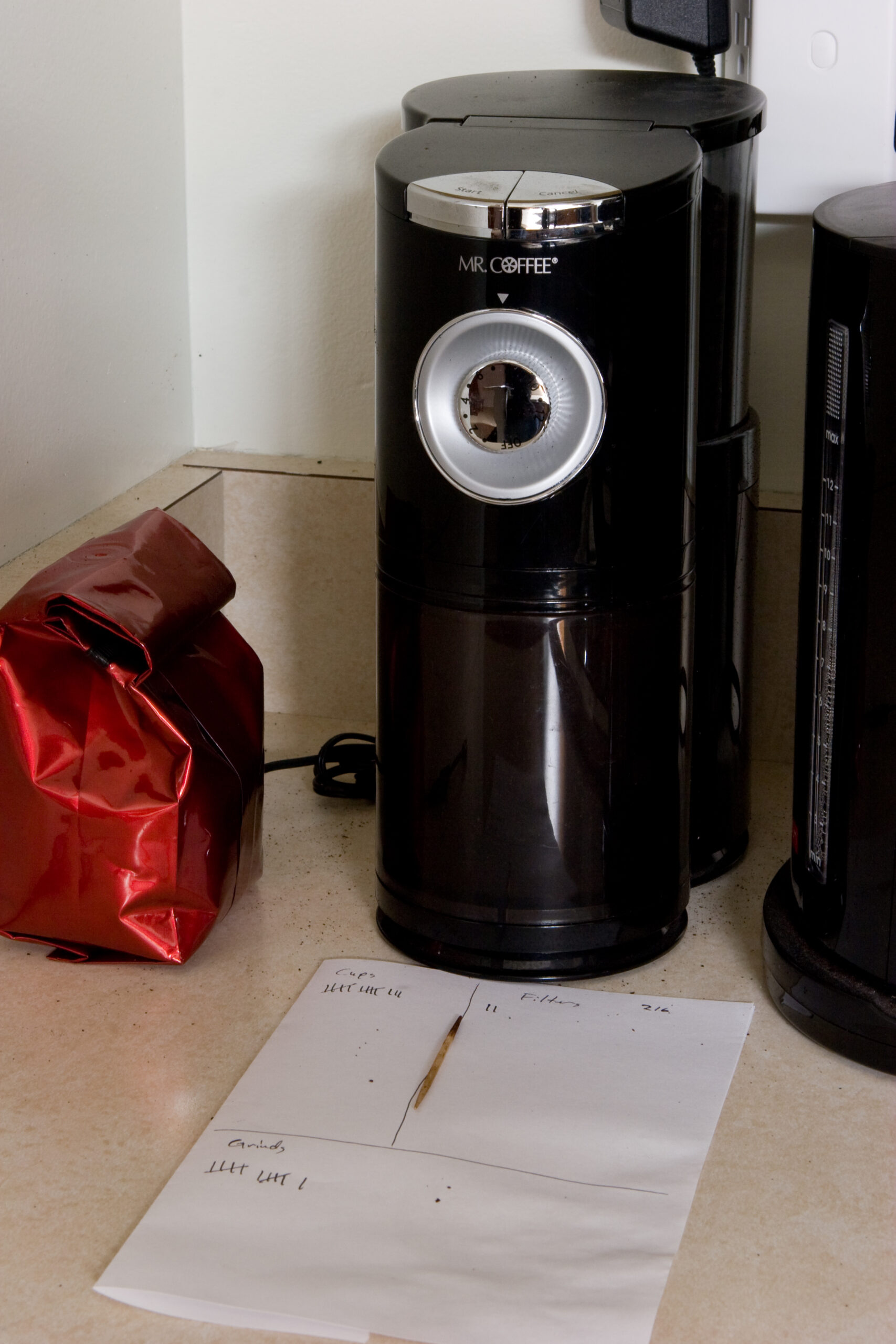 My coffee grinder, after cleaning a relatively minor clog, in the midst of figuring out how many servings I can make from one two pound bag of coffee.