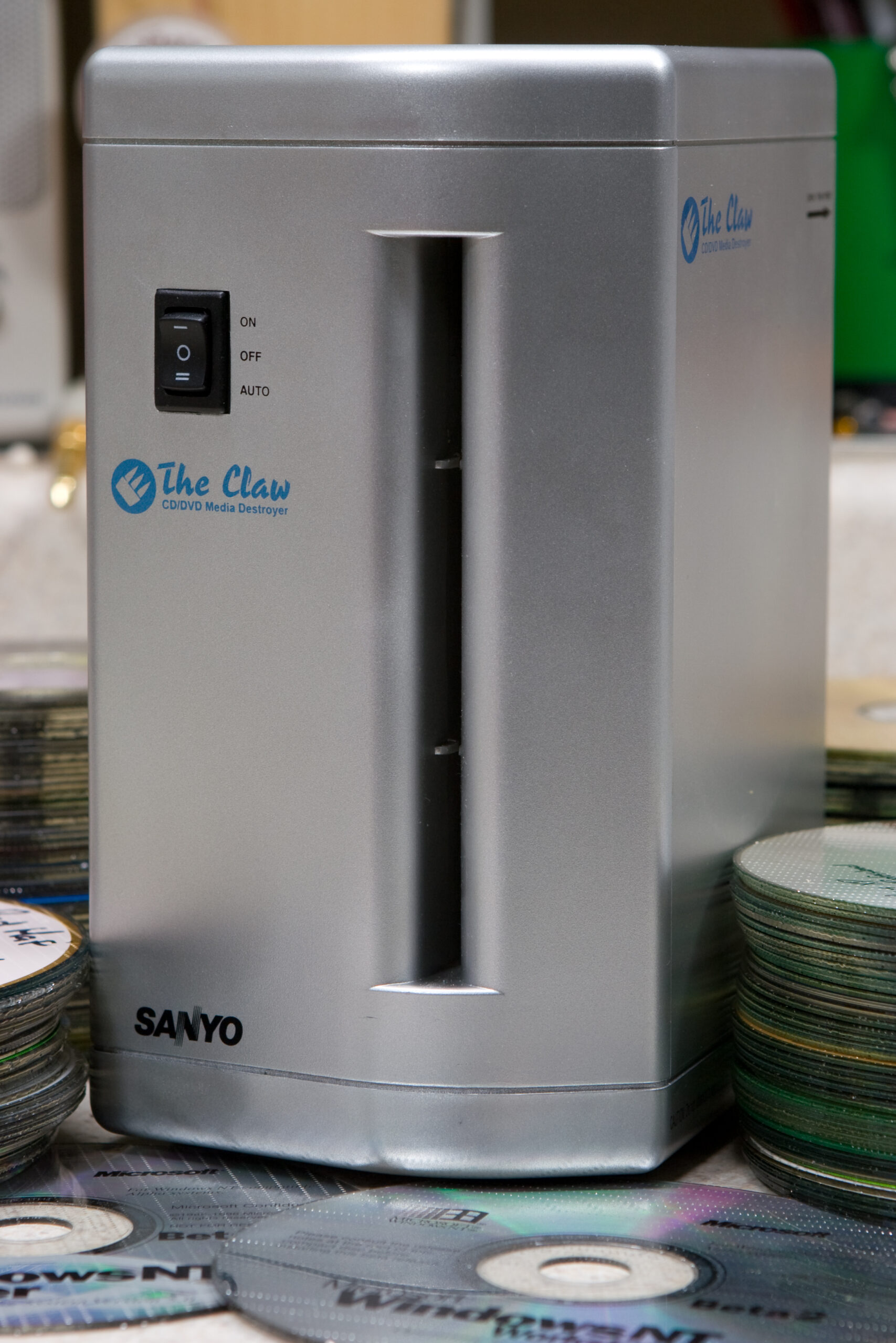 Sanyo The Claw CD/DVD Media Destroyer, model number CL-7, purchased from Woot for $4.99 (+$5 shipping). The piles of discs shown were destroyed one after another.