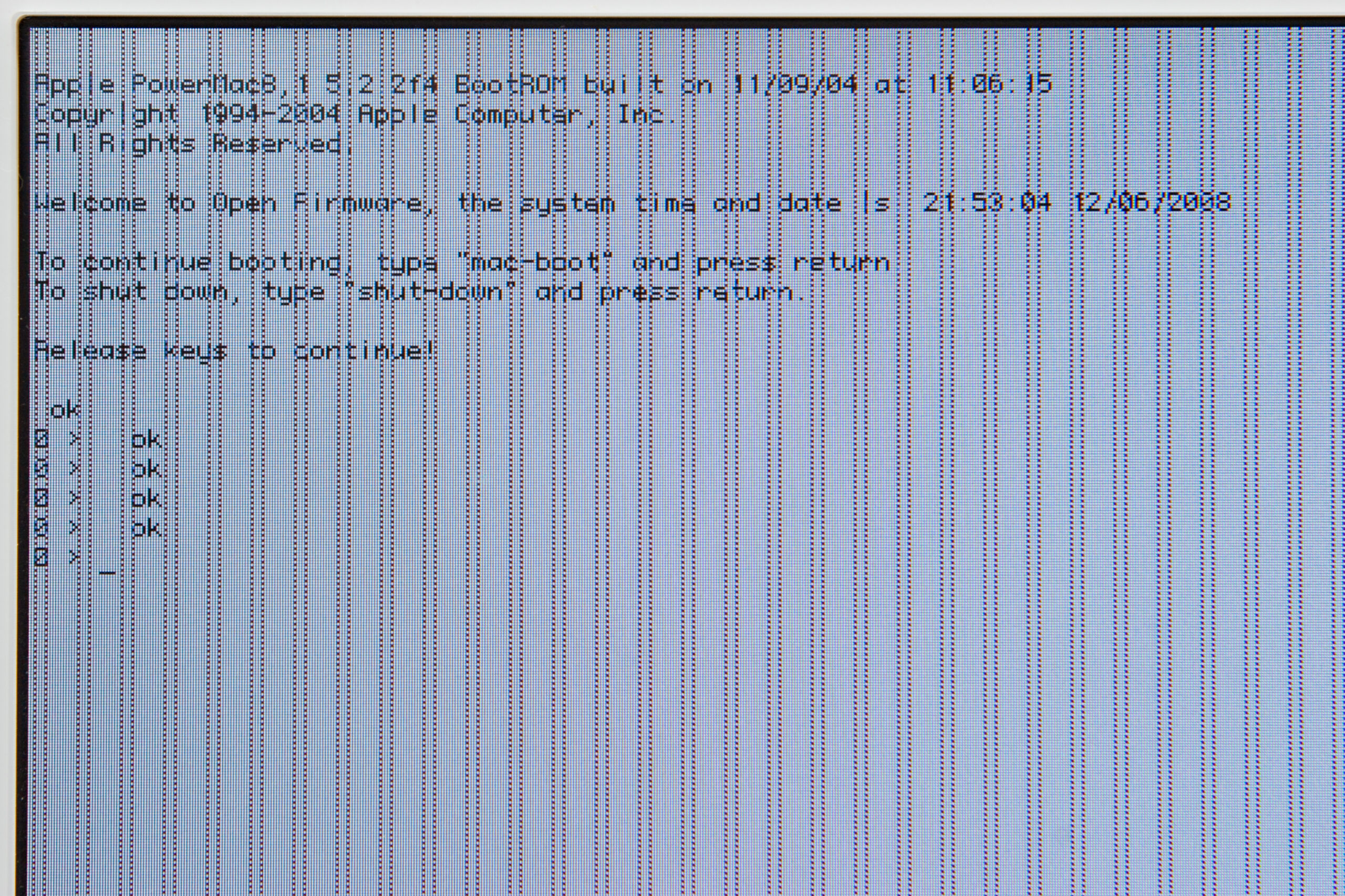 Image of the machine in Open Firmware showing video glitches present after recapping. I suspect that there are cold solder joints and the video card isn't getting proper power.