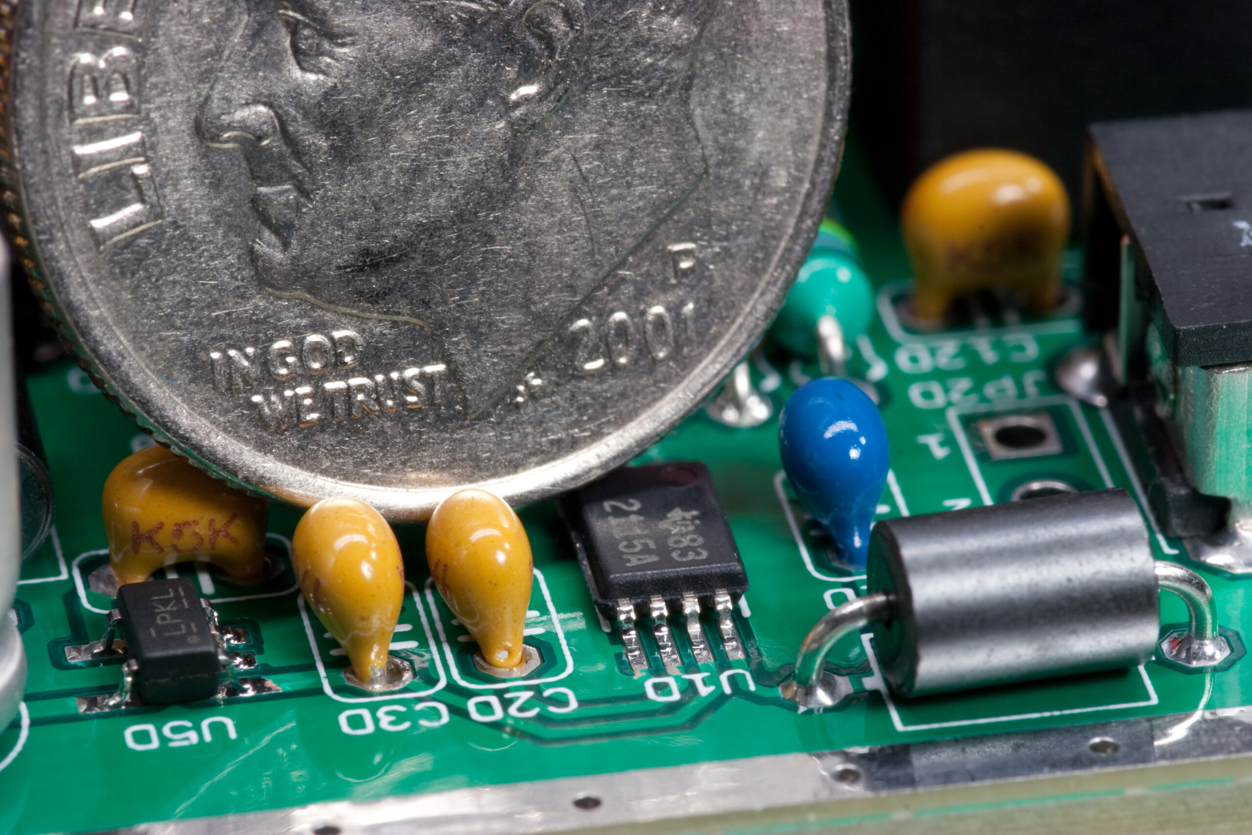 U1D, a Texas Instruments TPS2115APW compared to a US dime. This TSSOP-8 part is the finest pitched part on the board.