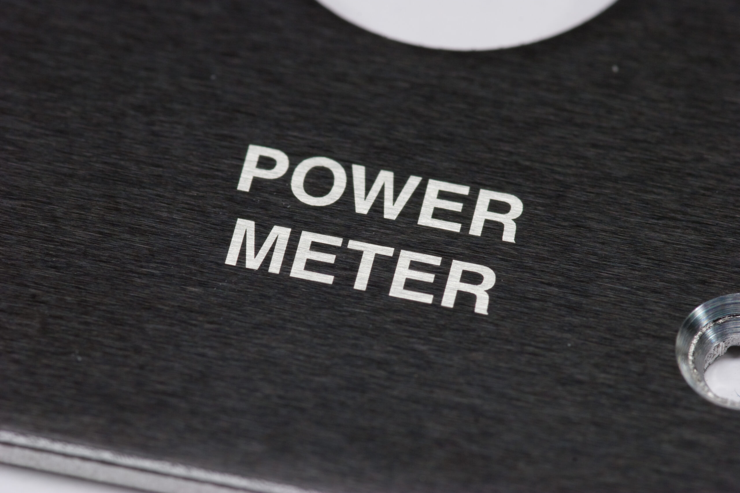 Detail of black and white text on sample panel material. This is about 5mm tall. The detail seems limited to the grain of the metal.