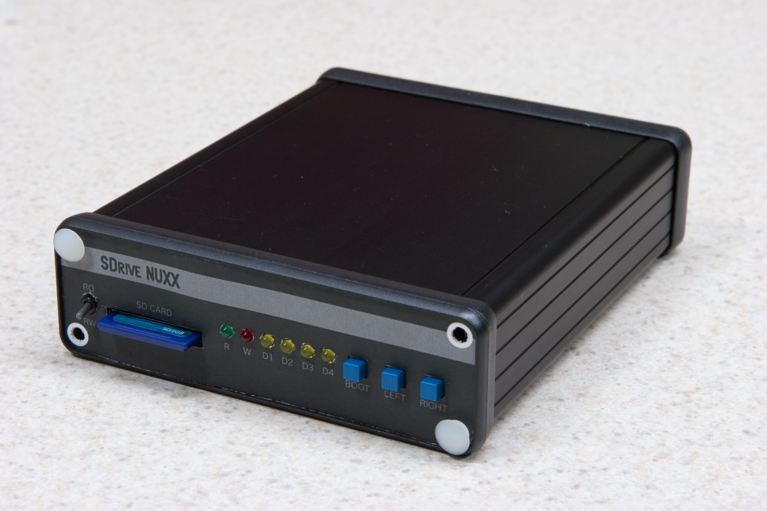 Cardboard mocked up front panel with the v1.0 / Prototype PCB in the enclosure. Production panel will be 1.5mm thicker.