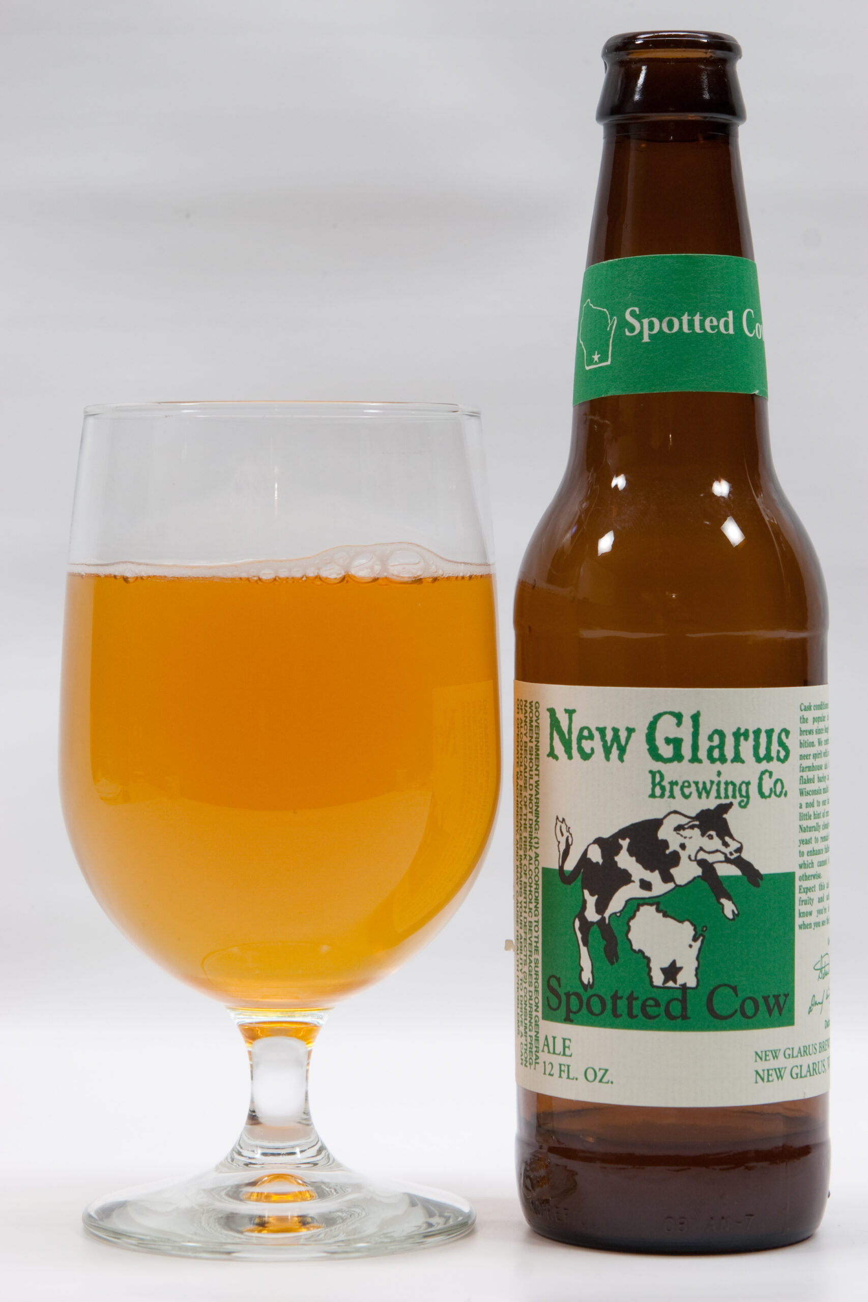 New Glarus Brewing Company's Spotted Cow poured into a glass. It reminds me of both Blue Moon and Oberon, which means that I don't particularly care for it.