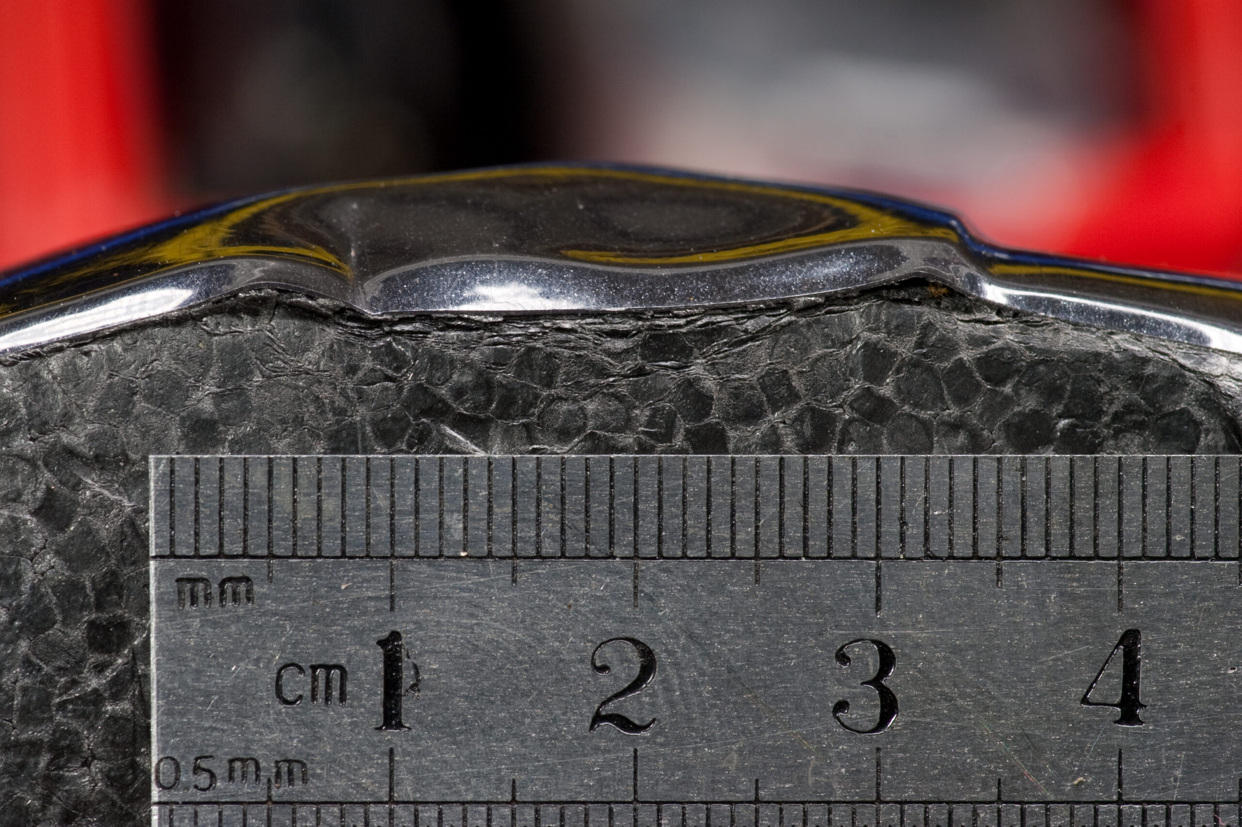 Another photo of the damage to my old helmet, this time with a scale.