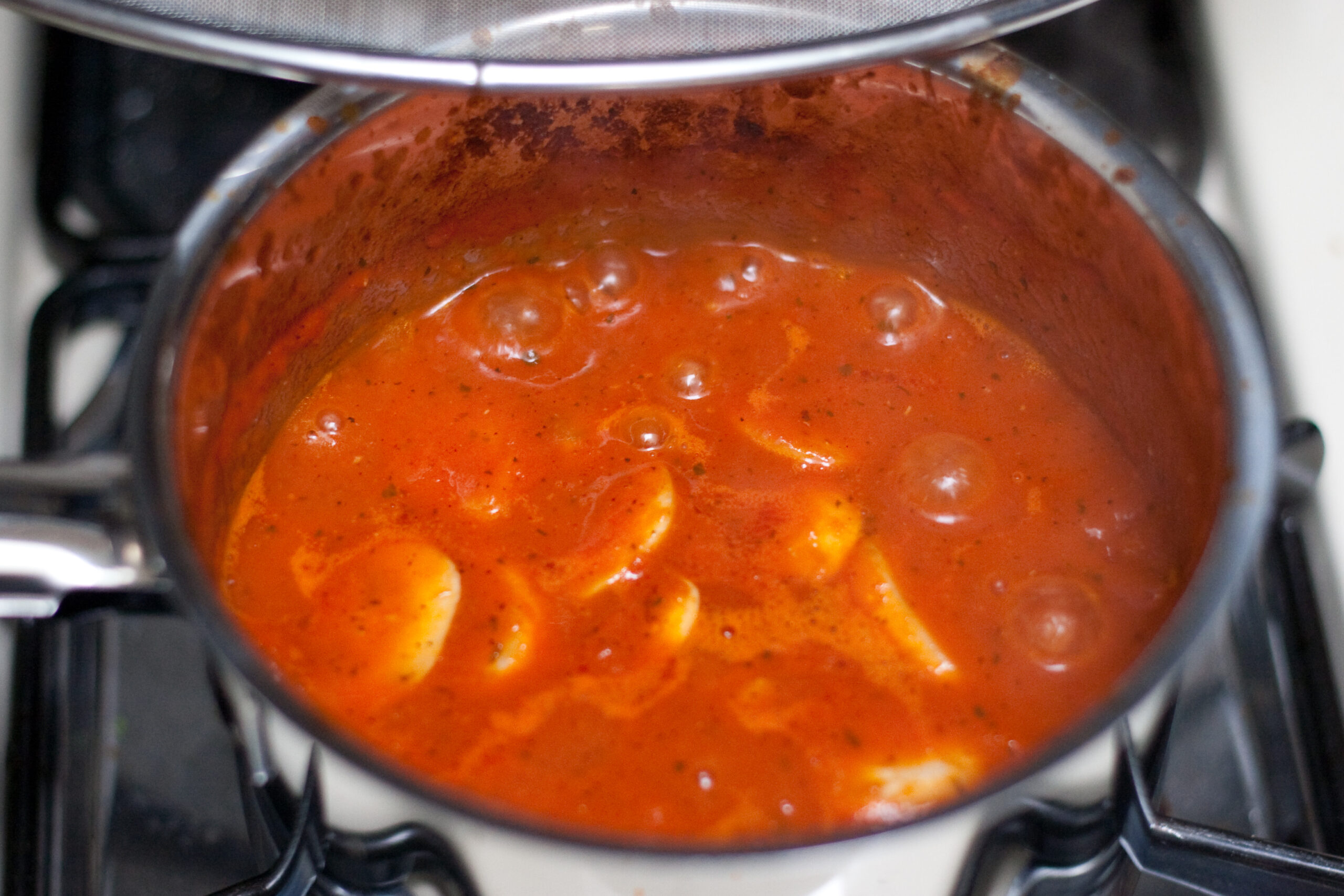 Tomato sauce that I'm cooking down for use on sandwhiches. It is Trader Joe's fire roasted tomatos and chilis, garlic, olive oil, oregano, salt, and pepper blended together with mushrooms.