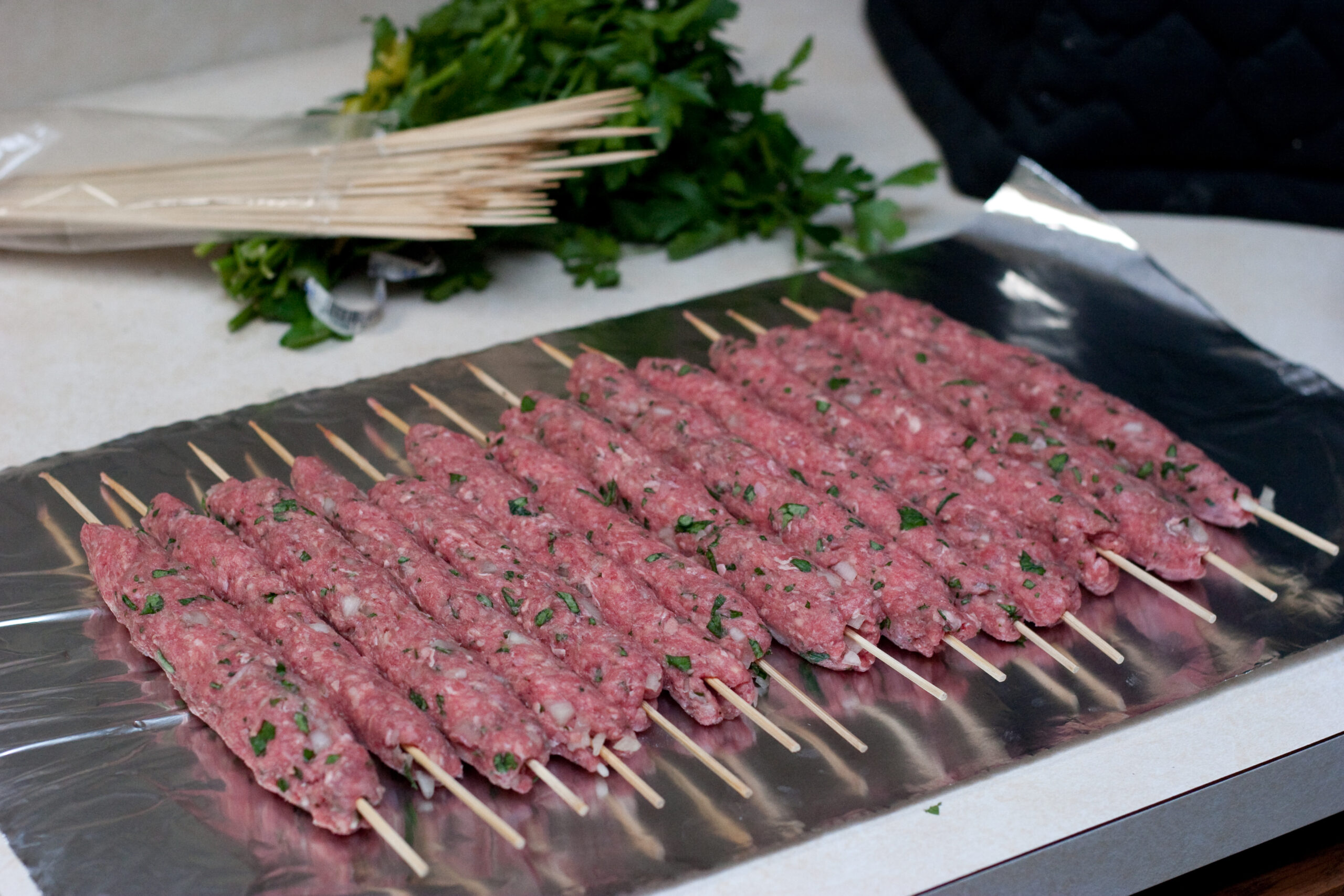 Danielle's kofta, on skewers, ready to be cooked.