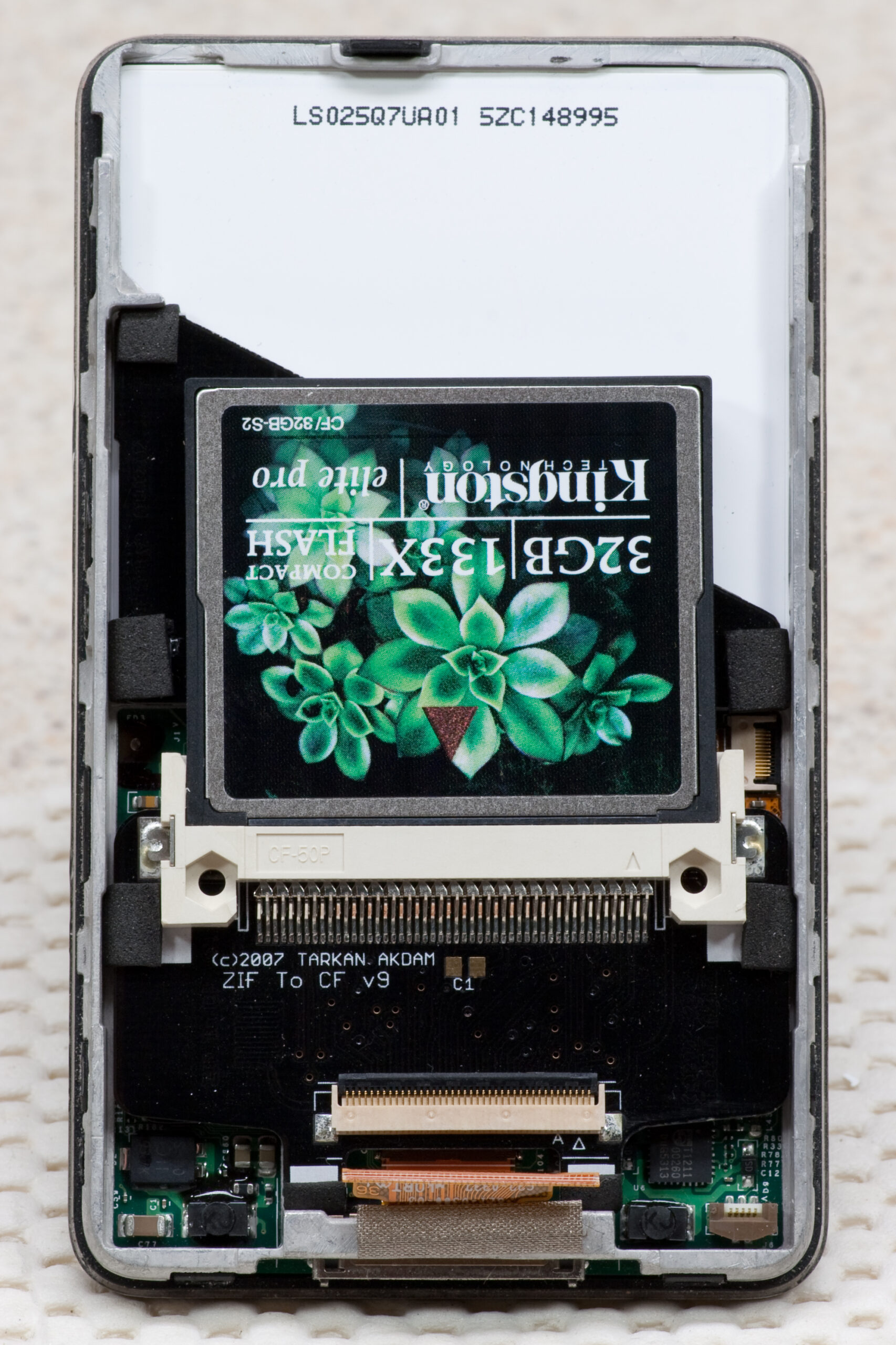 Detail of the iFlash iPod Compact Flash Adapter (mk II) fit inside of my iPod, disconnected. Note that the foam ensures a snug fit within the metal frame.