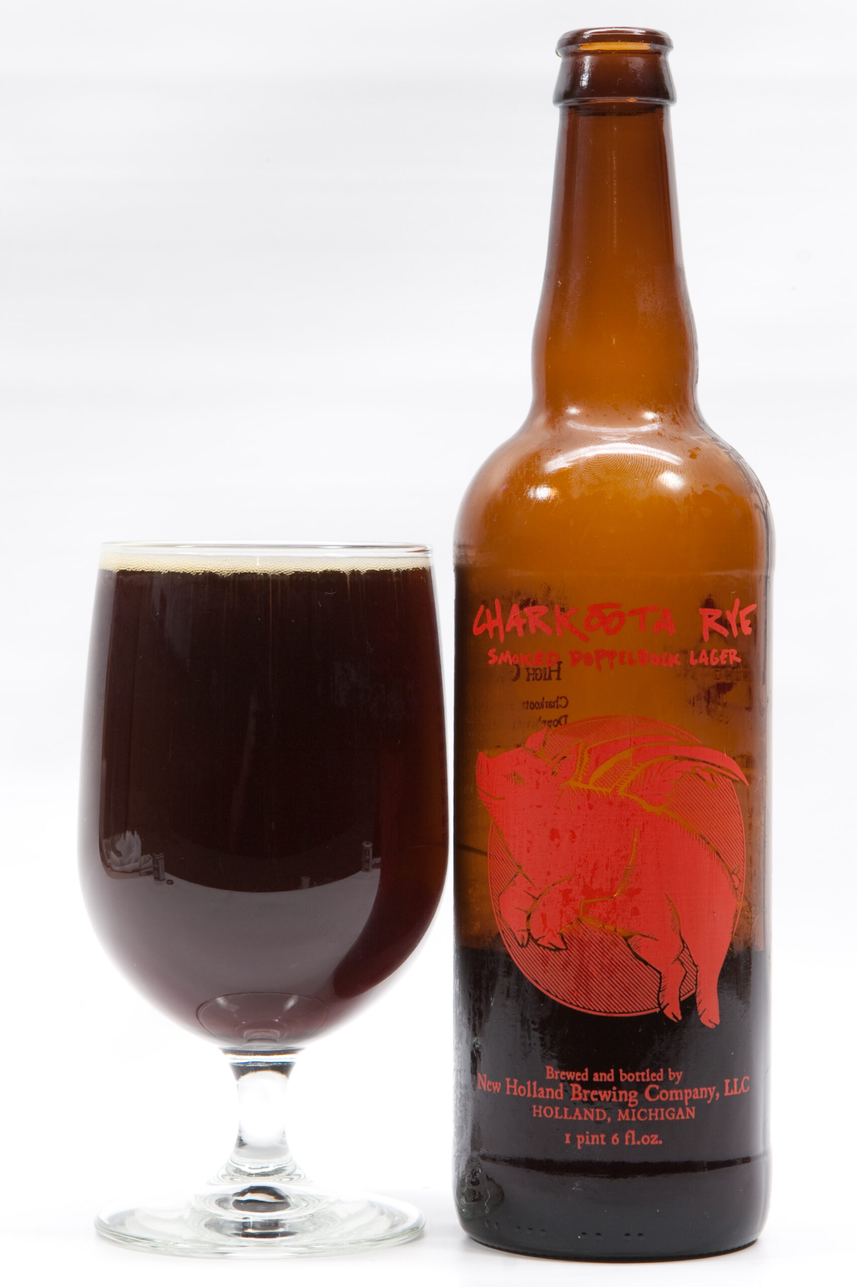 New Holland's Charkoota Rye Smoked Doppelbock Lager poured into a glass. It's surprisingly smokey, a bit malty, and dry tasting. It gets better as it warms, and is rather nice. 8.17% ABV.