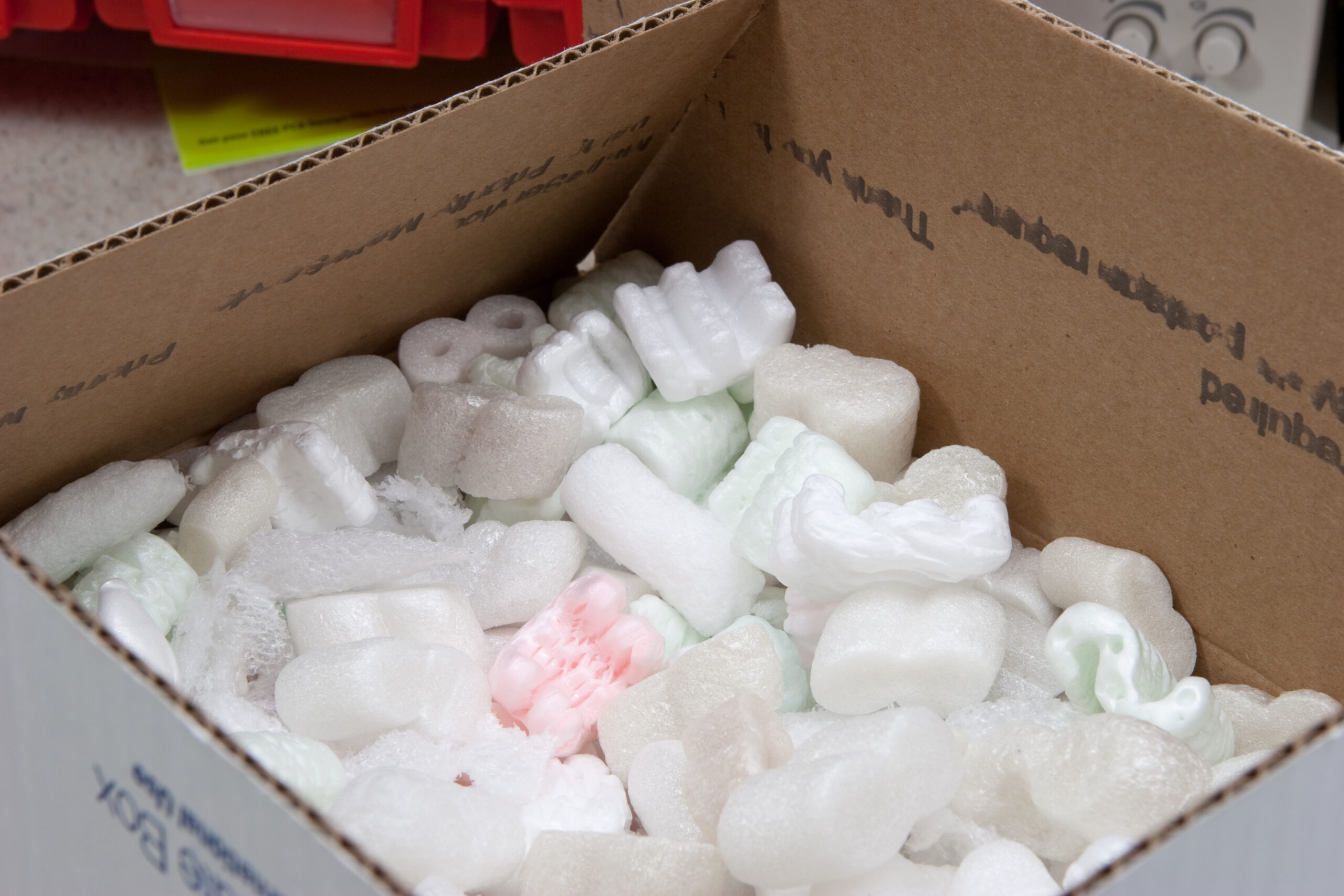 When packing with foam peanuts it is important to ensure that there are enough to hold the items tightly. This is done by slightly overfilling the box then compressing them while closing the box.
