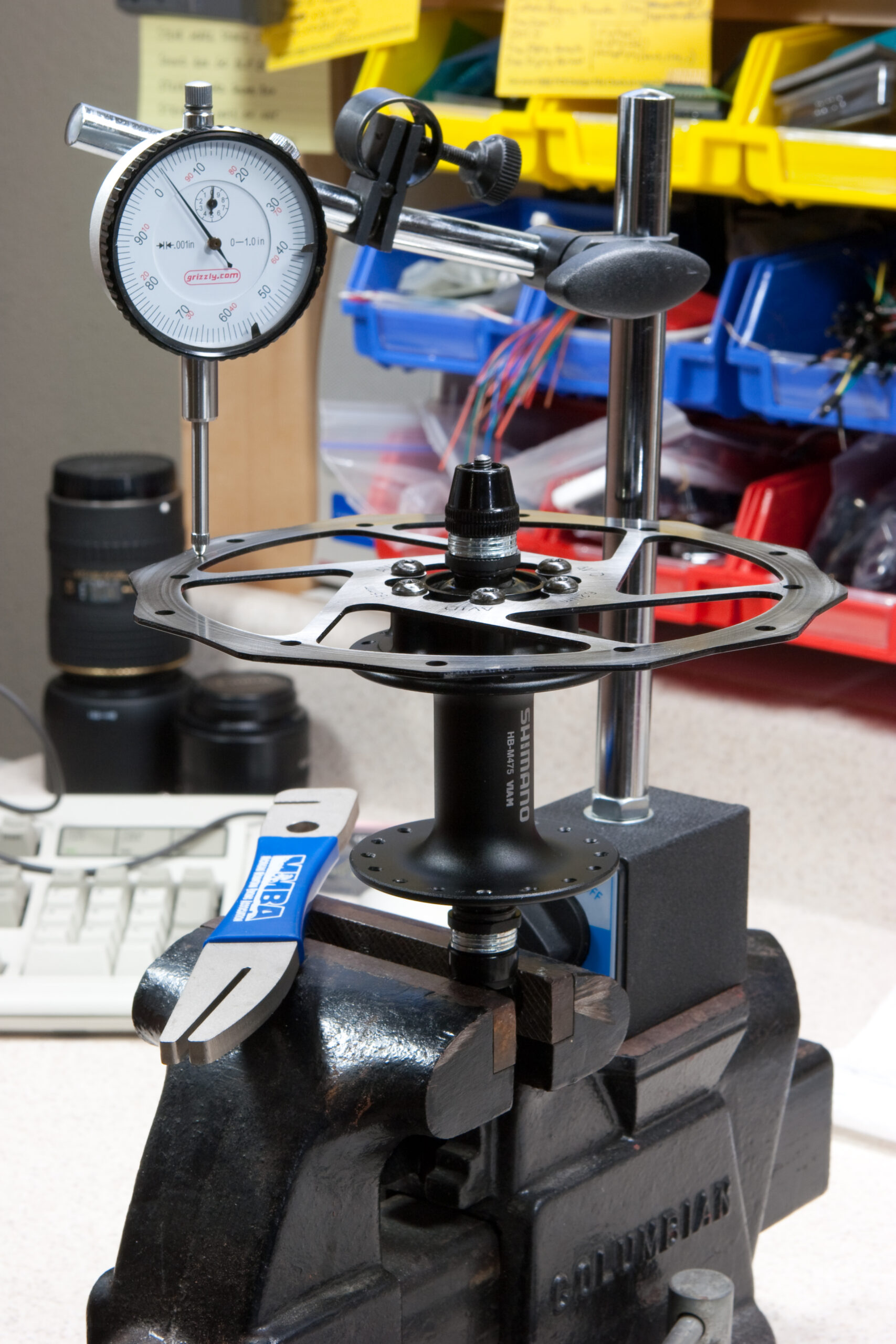 Using a borrowed dial indicator, a bench vise, and an old hub to true a bicycle disc brake rotor (Avid Roundagon, 185mm).