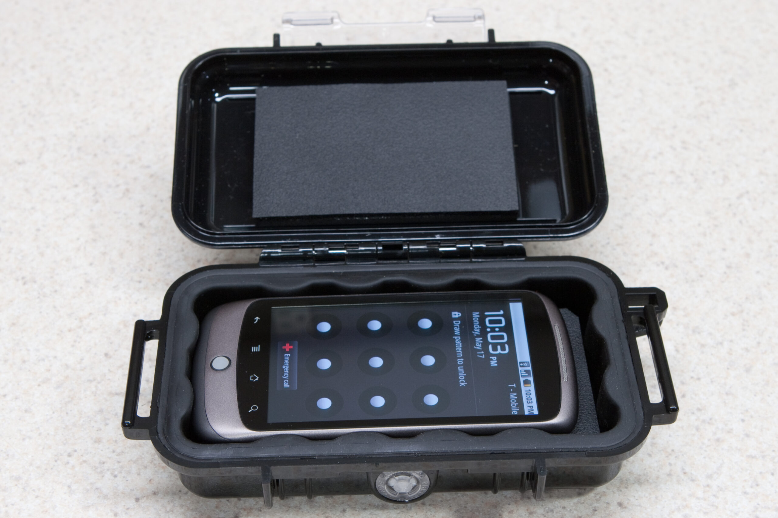 Google Nexus One tucked into the Pelican 1015 with extra foam beneath it and inside the lid. The phone does not rattle, slide around, or come loose when the case is shaken.