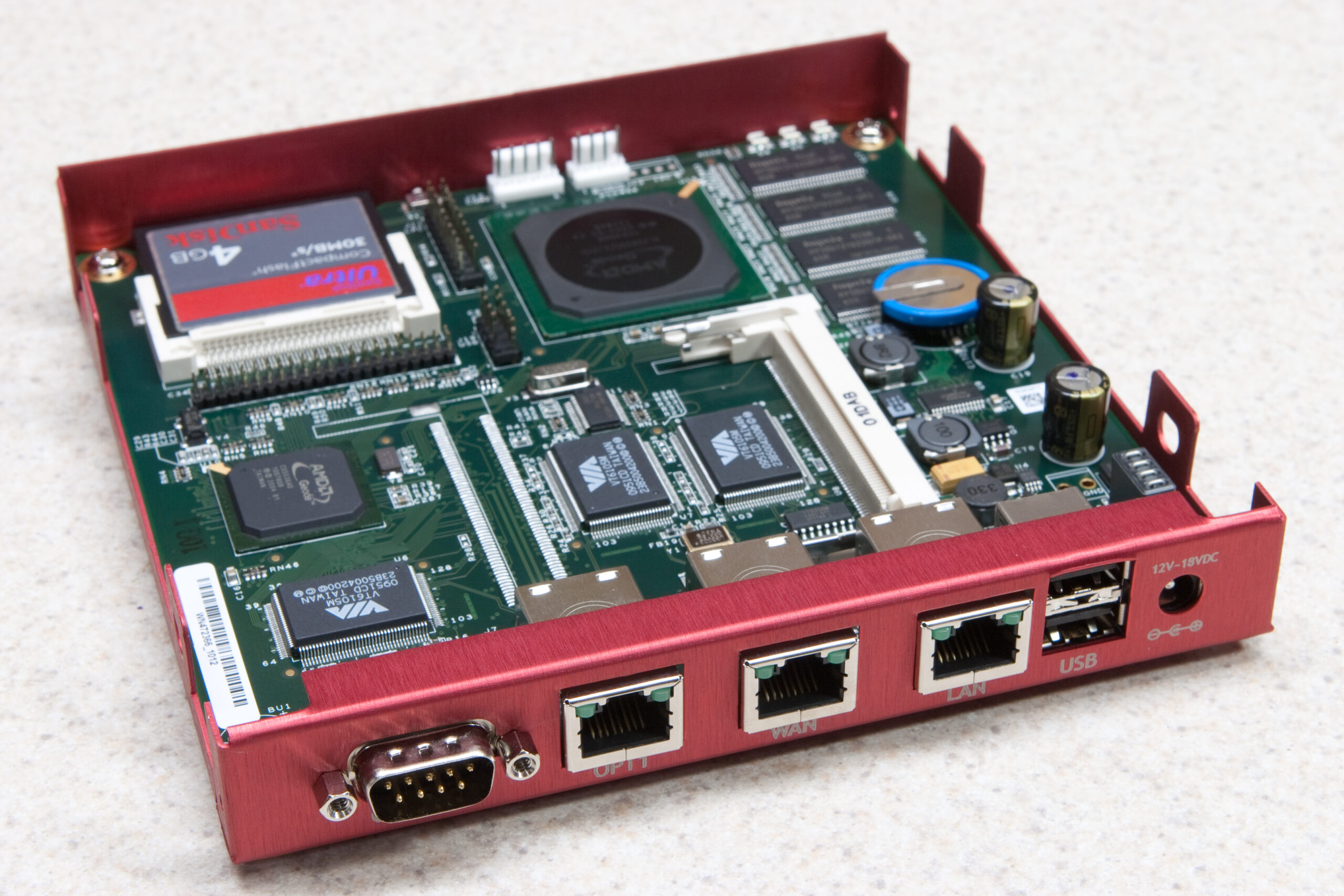 Rear view of the PC Engines alix2d13 PCB in Netgate enclosure, showing the various ports and their labels.