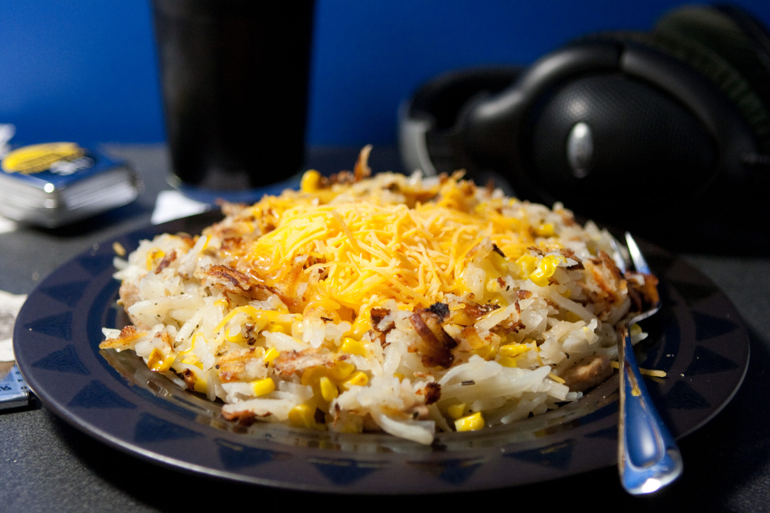 Hash browns with onion, roasted garlic, rosemary, spicy chicken sausage, and sweet corn topped with mild cheddar. With a glass of Bell's Kalamazoo Stout it's a very nice post-bike ride dinner.