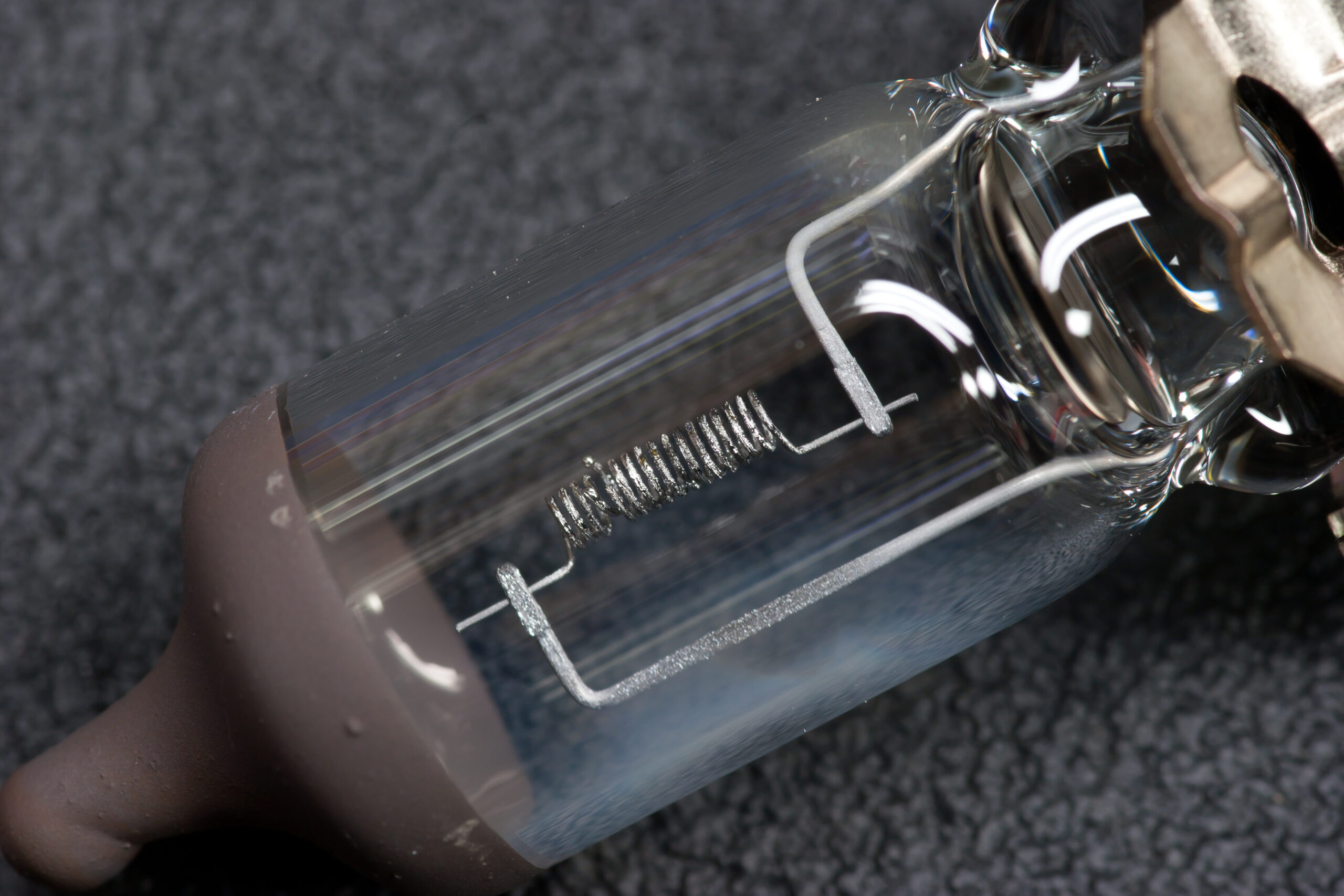 Detail of a burnt-out 9006 bulb from my 2006 Honda Civic EX's headlight. Evaporated filament material can be seen clouding the glass.