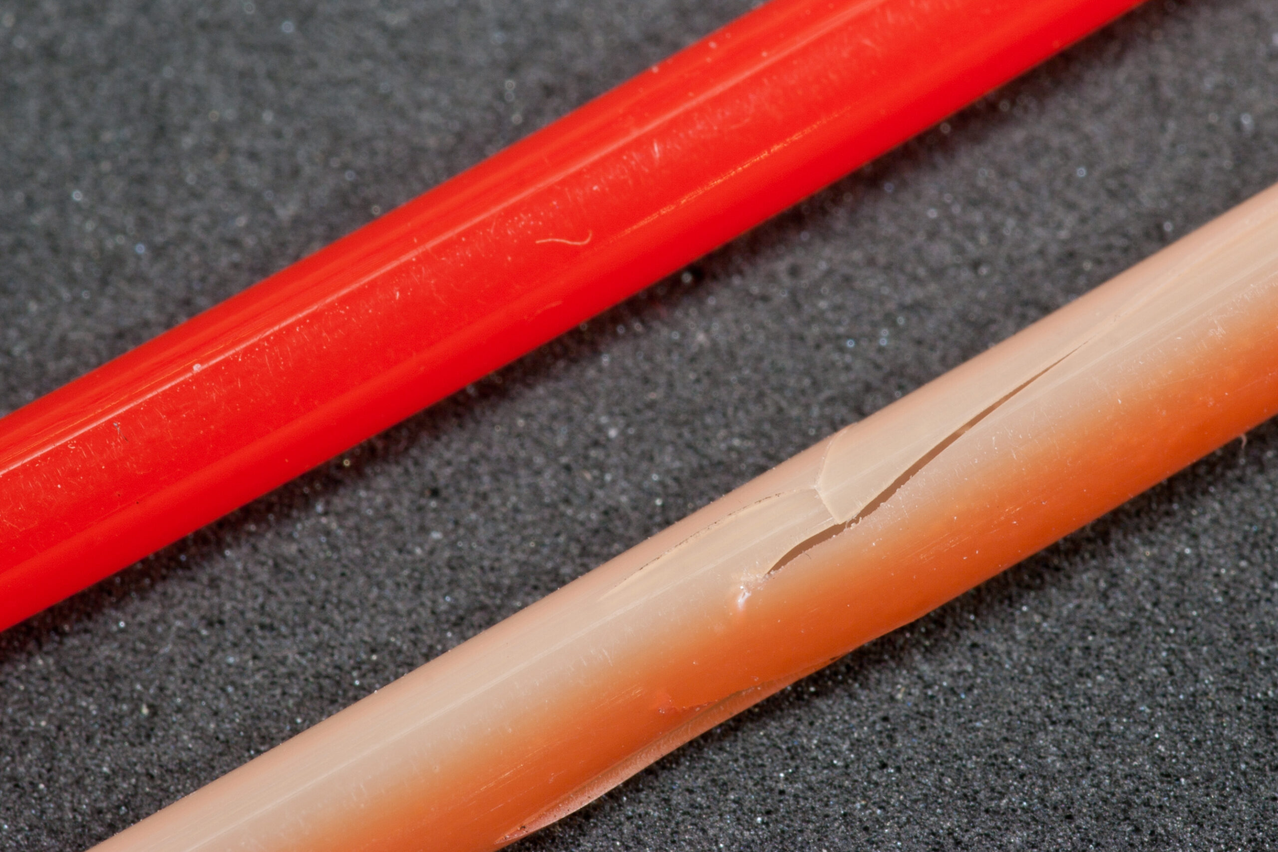 Red plastic tubing from SRAM Flak Jacket cable sets, designed to cover exposed shift cables, decays in sunlight and becomes ugly, discolored, and brittle.