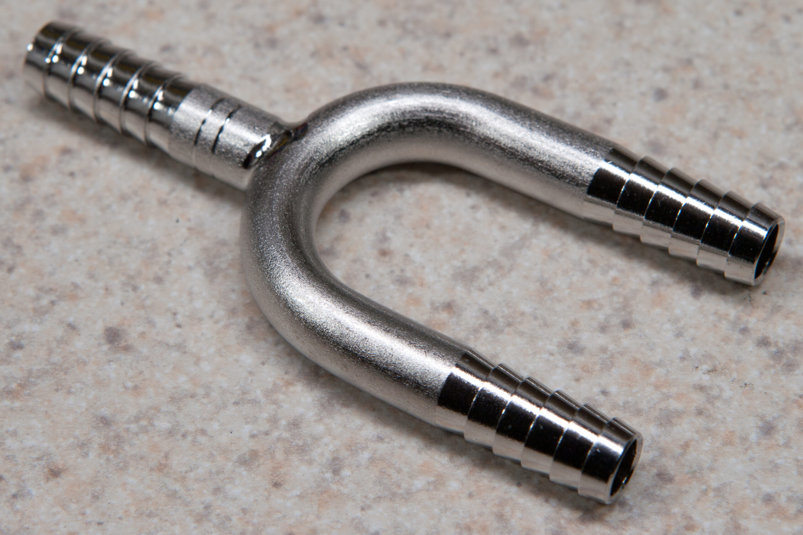 Stainless steel barbed Y fitting for 1/4" gas line.