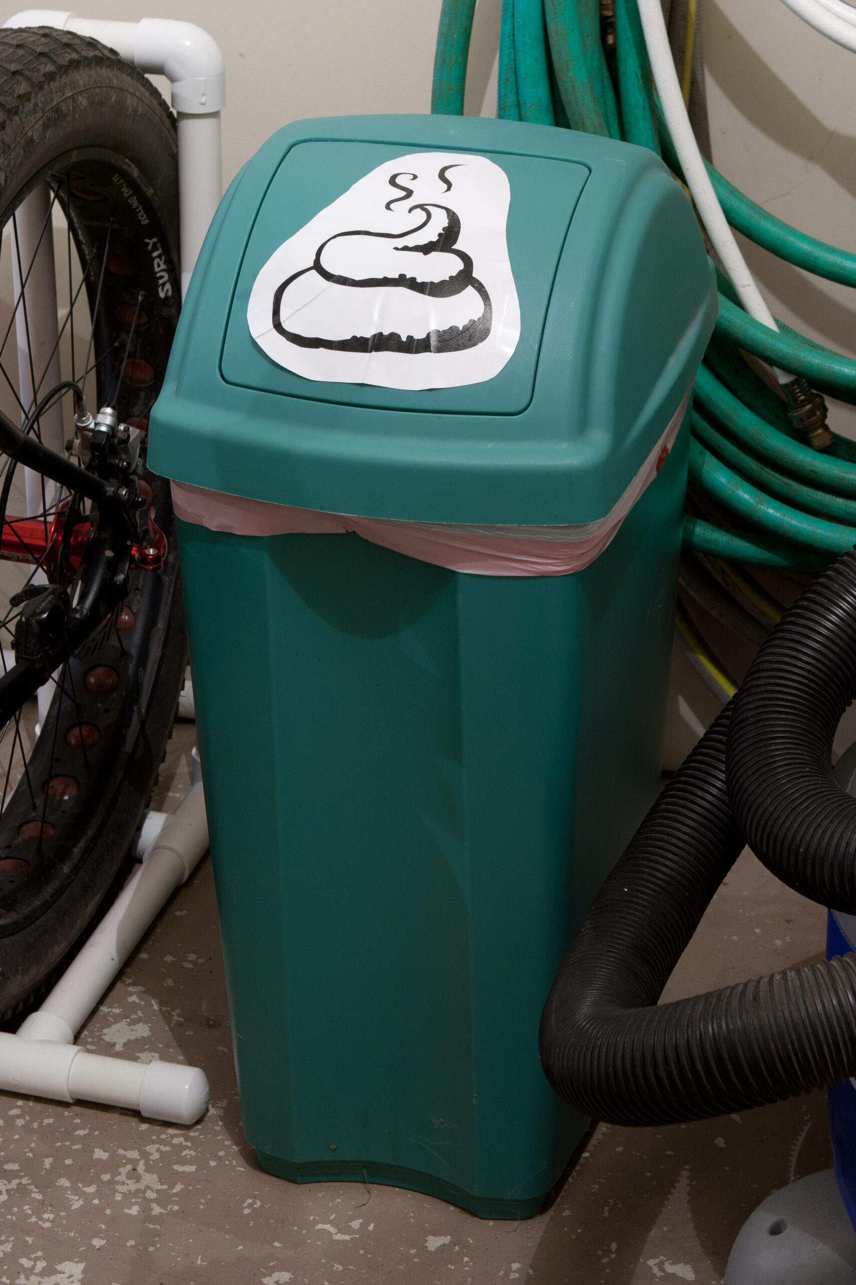 U+1F4A9 (PILE OF POO) used to label a garbage can in the garage containing Roxie's poop.