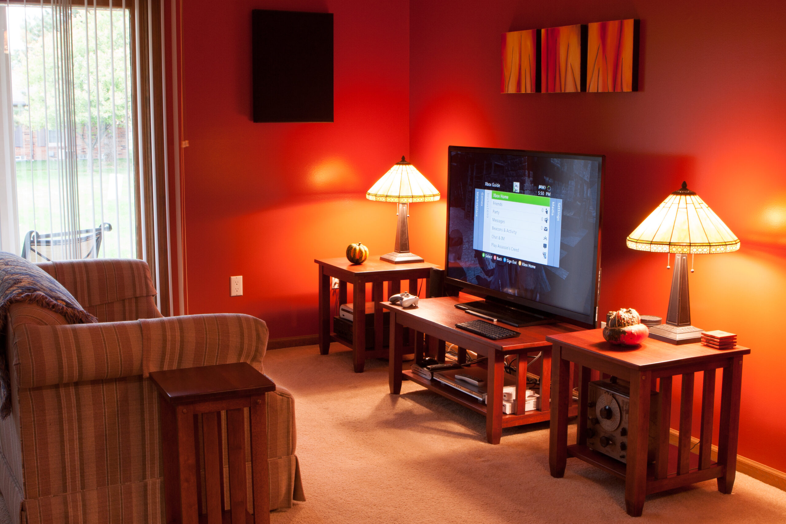 Living room shuffled around to include a Sharp LC-52LE640U TV, two-channel audio, DVD player, a HTPC, and a few game consoles.