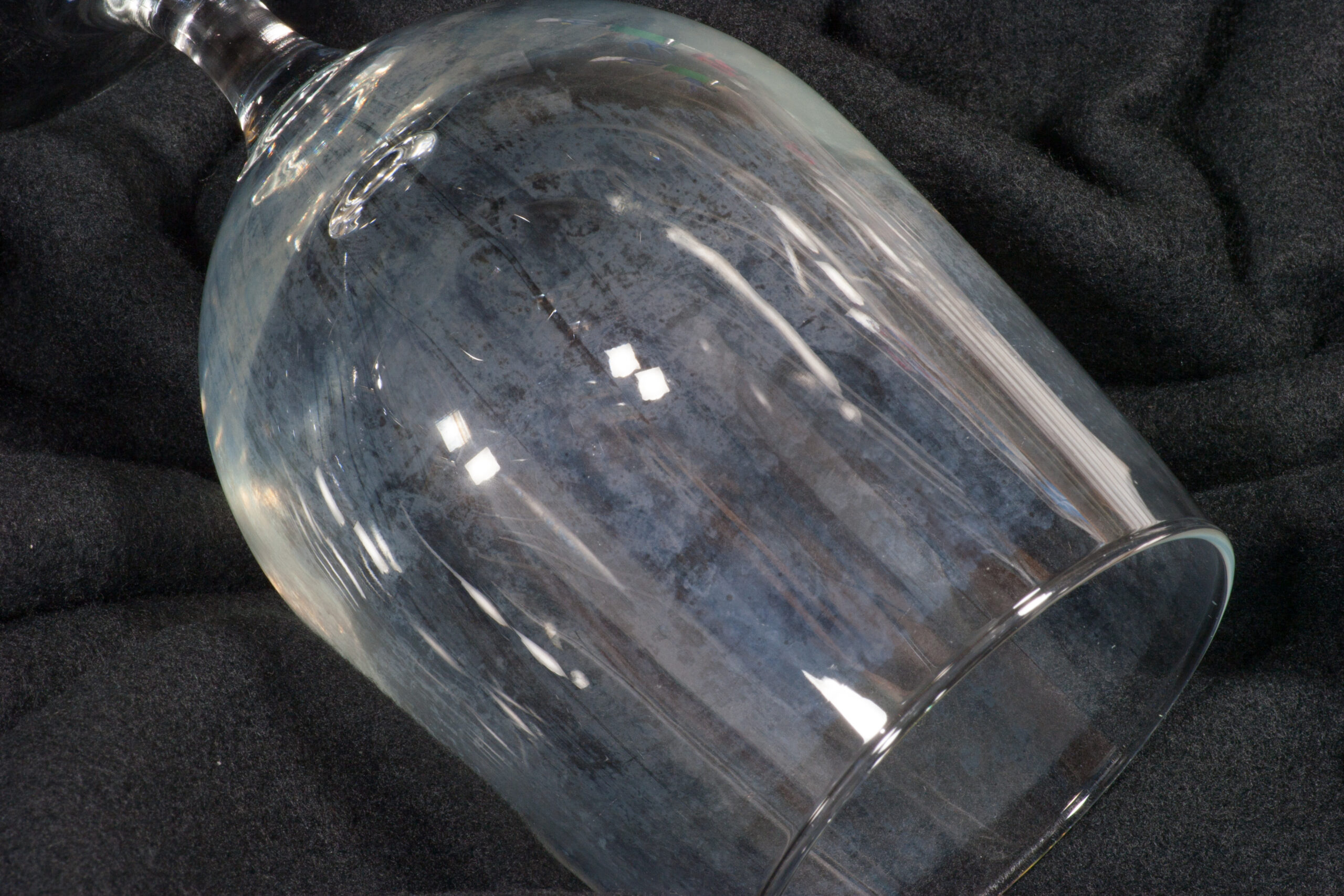 Water glass, frequently used for beer, with hard water deposits on the surface.