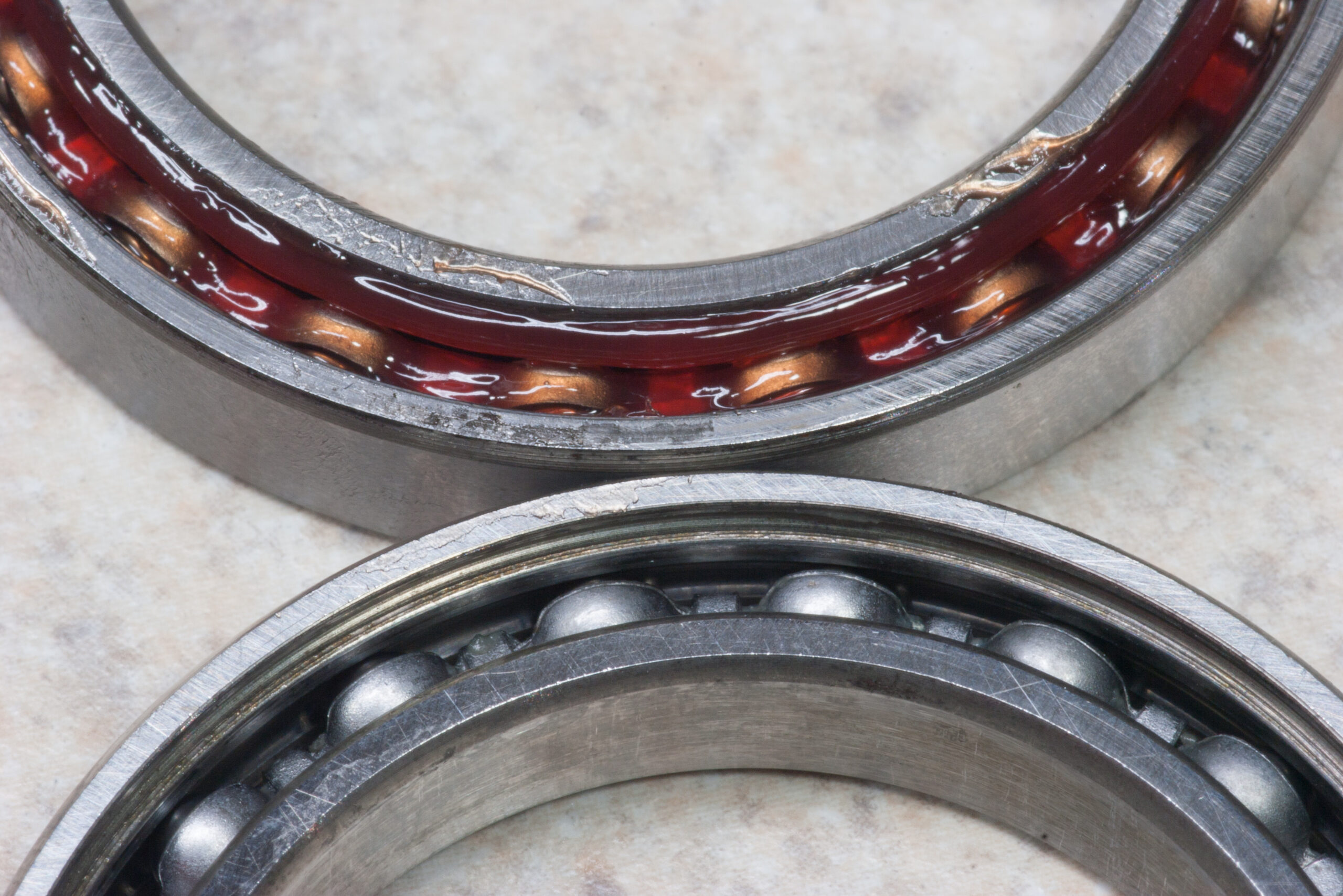 KML 6806-2RS bearings with the seals removed and cleaned of factory grease after one seal started making noise. Upper bearing is refilled with ProGold EPX Cycle Grease.