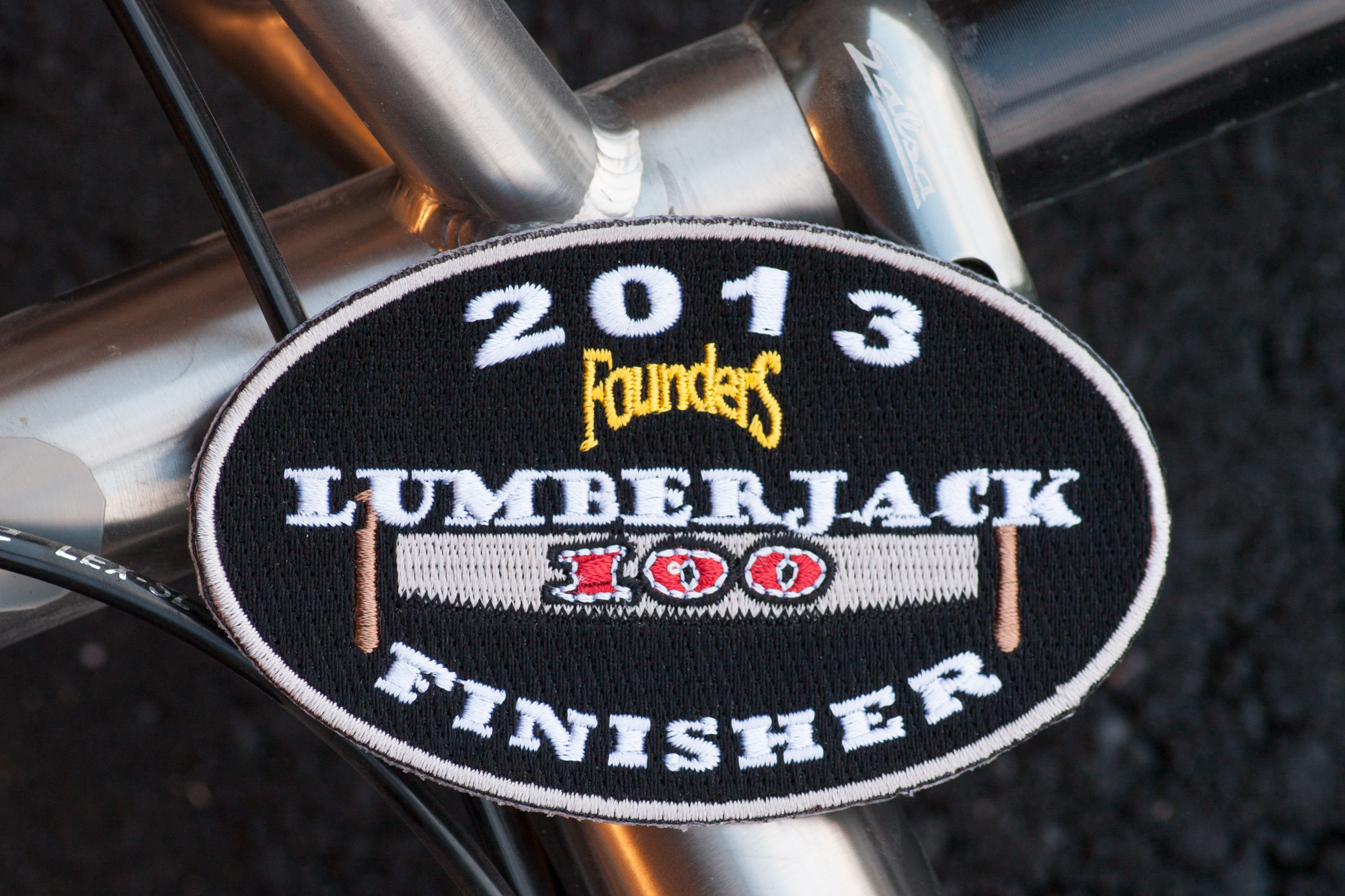 2013 Lumberjack 100 finisher patch, sitting on the Salsa El Mariachi Ti frame at the seat tube / top tube junction.