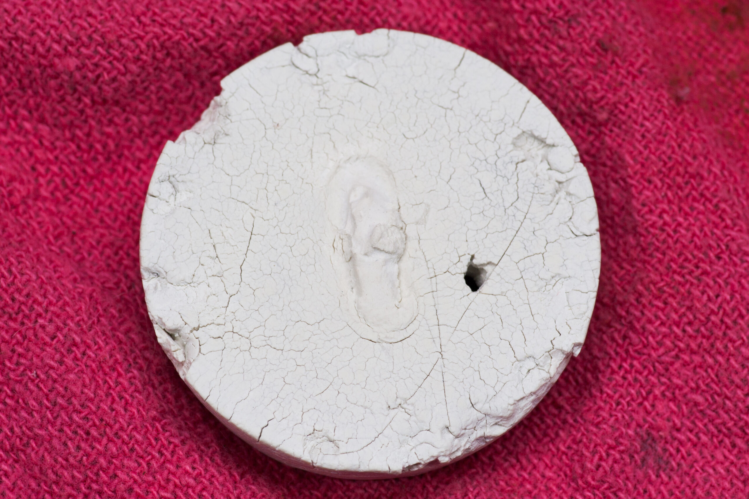 Twelve year old 1 1/2" rubber stopper that was no longer effective and featured a hole made when trying to remove it from the drain with a metal tool.
