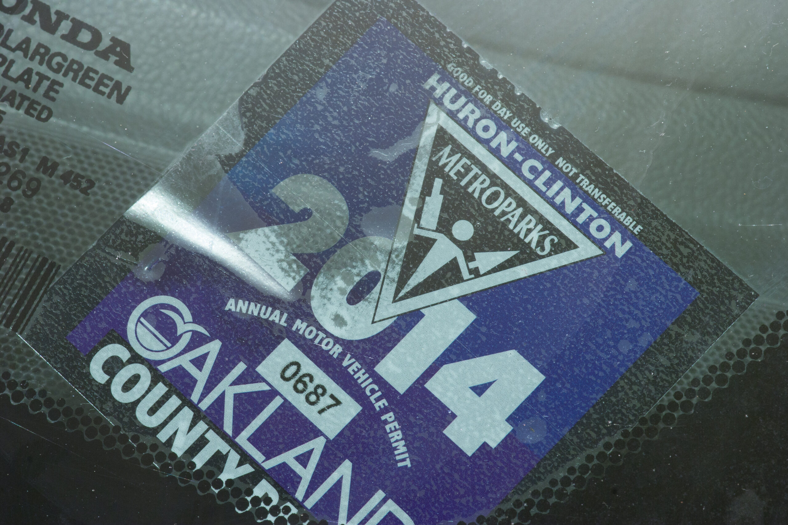 The 2014 Huron-Clinton join Metroparks / Oakland County Parks sticker is a new style, with tear marks at the top, split backing, and alcohol soluble paint on the back.