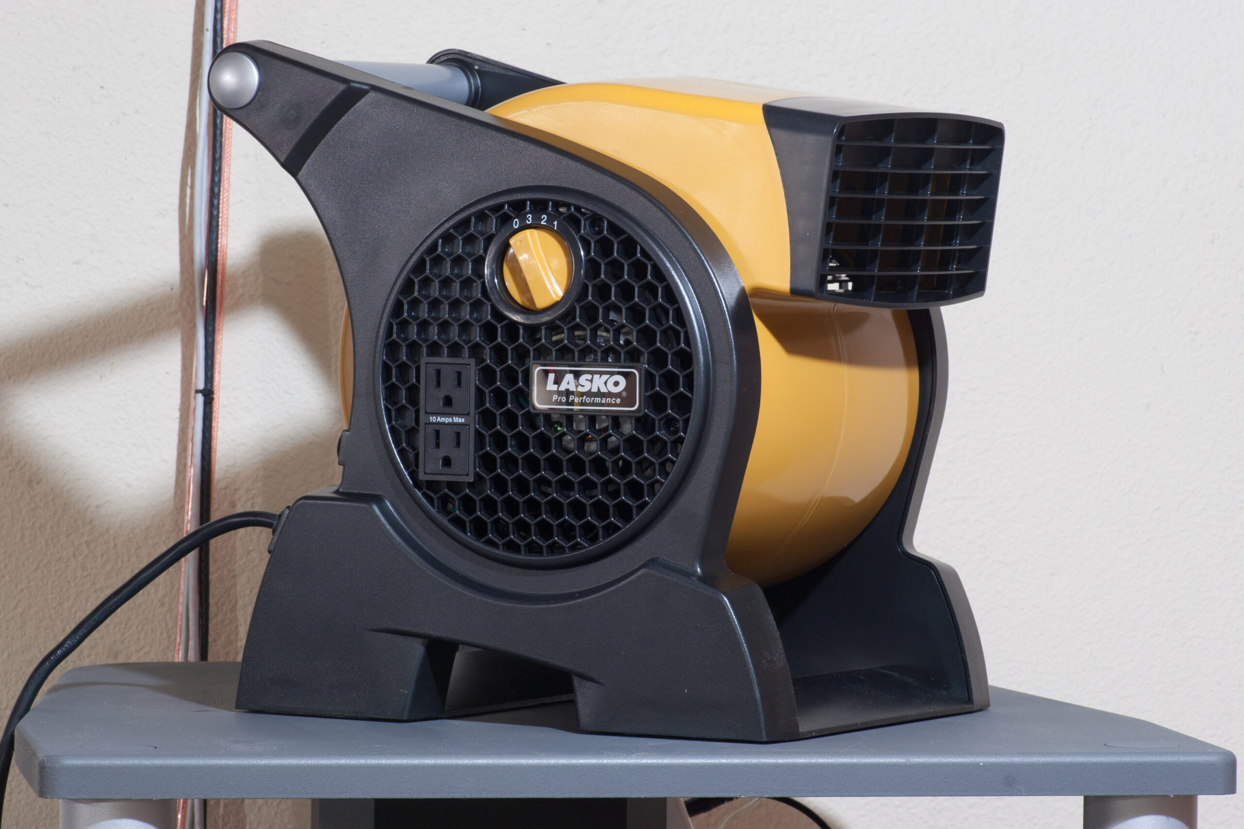 Lasko Pro-Performance High Velocity Utility Fan (Model 4900) sitting on top of the equipment stand in the basement where I'll use it while riding on a trainer.