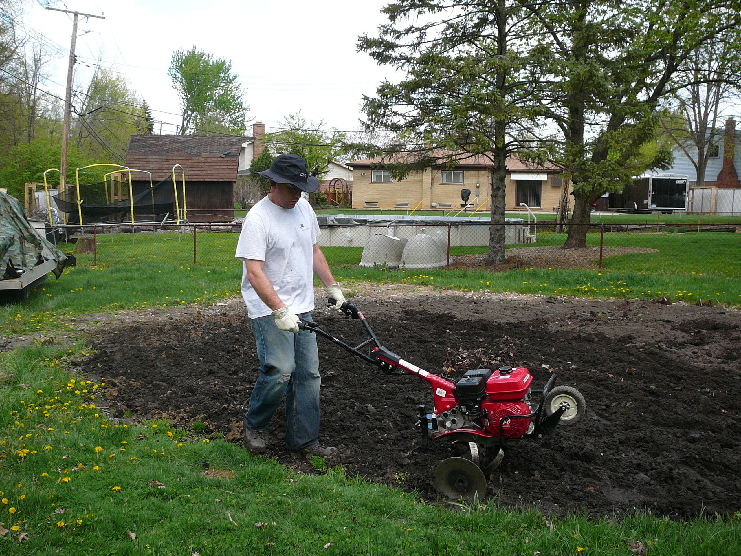 Tilling the garden in Danielle's back yard which is being put where their pool had previously been.