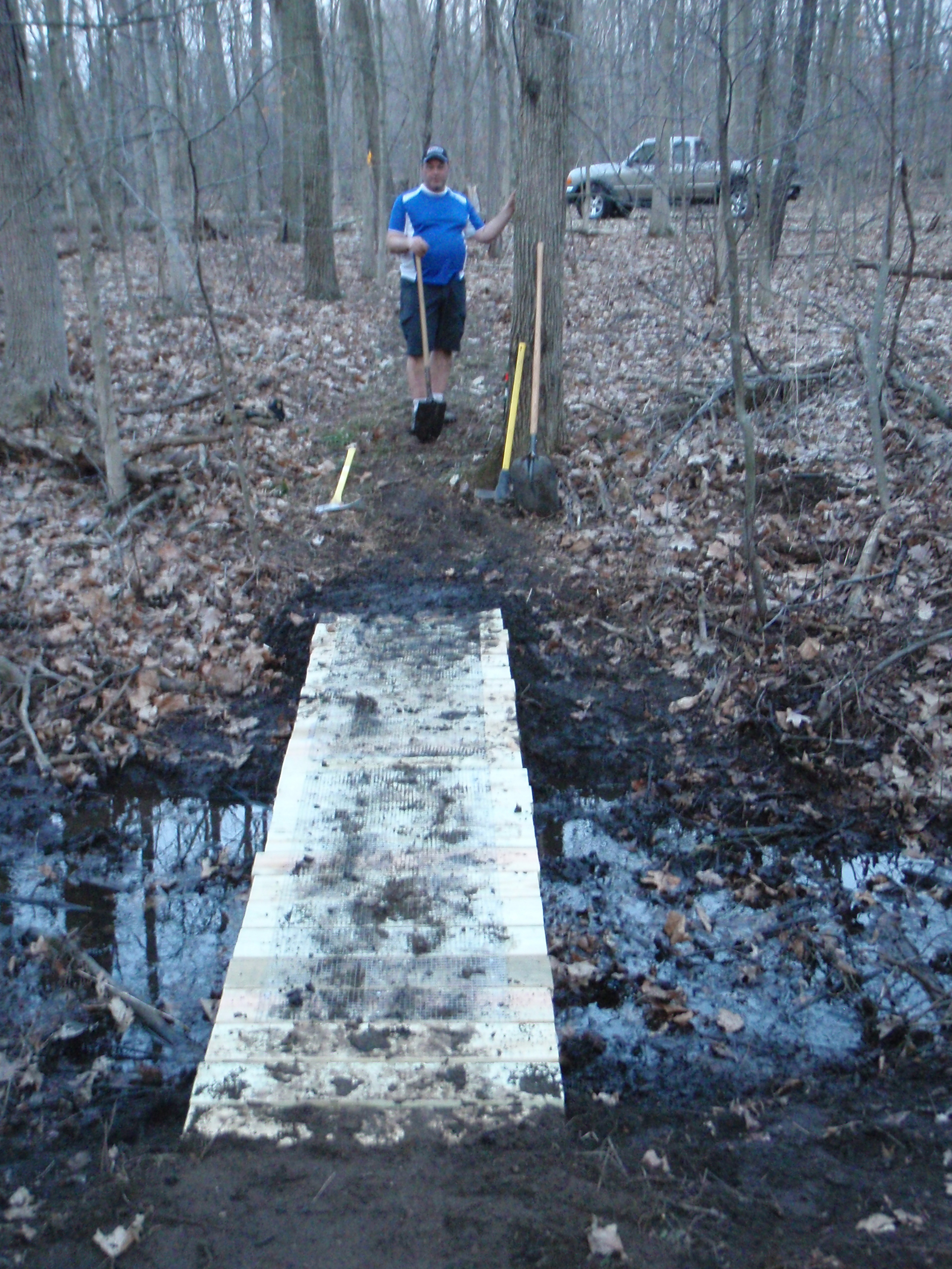 Mark standing on the south side of the bridge after we begun burying the ends and completed one evening of work.