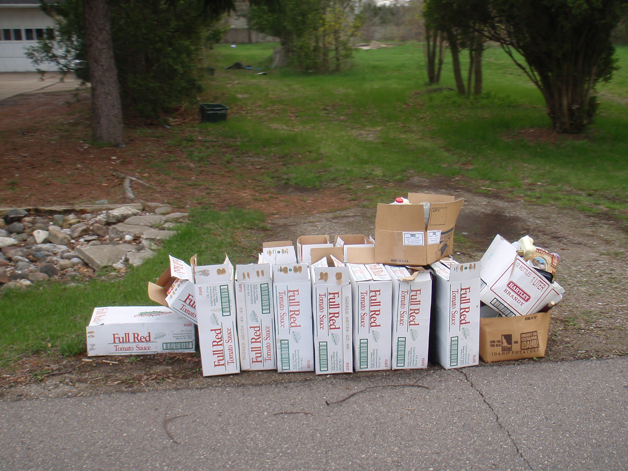 Fourteen cases of Full Red Tomato Sauce cans being thrown out along Wiloray Ave. in Shelby Township.
