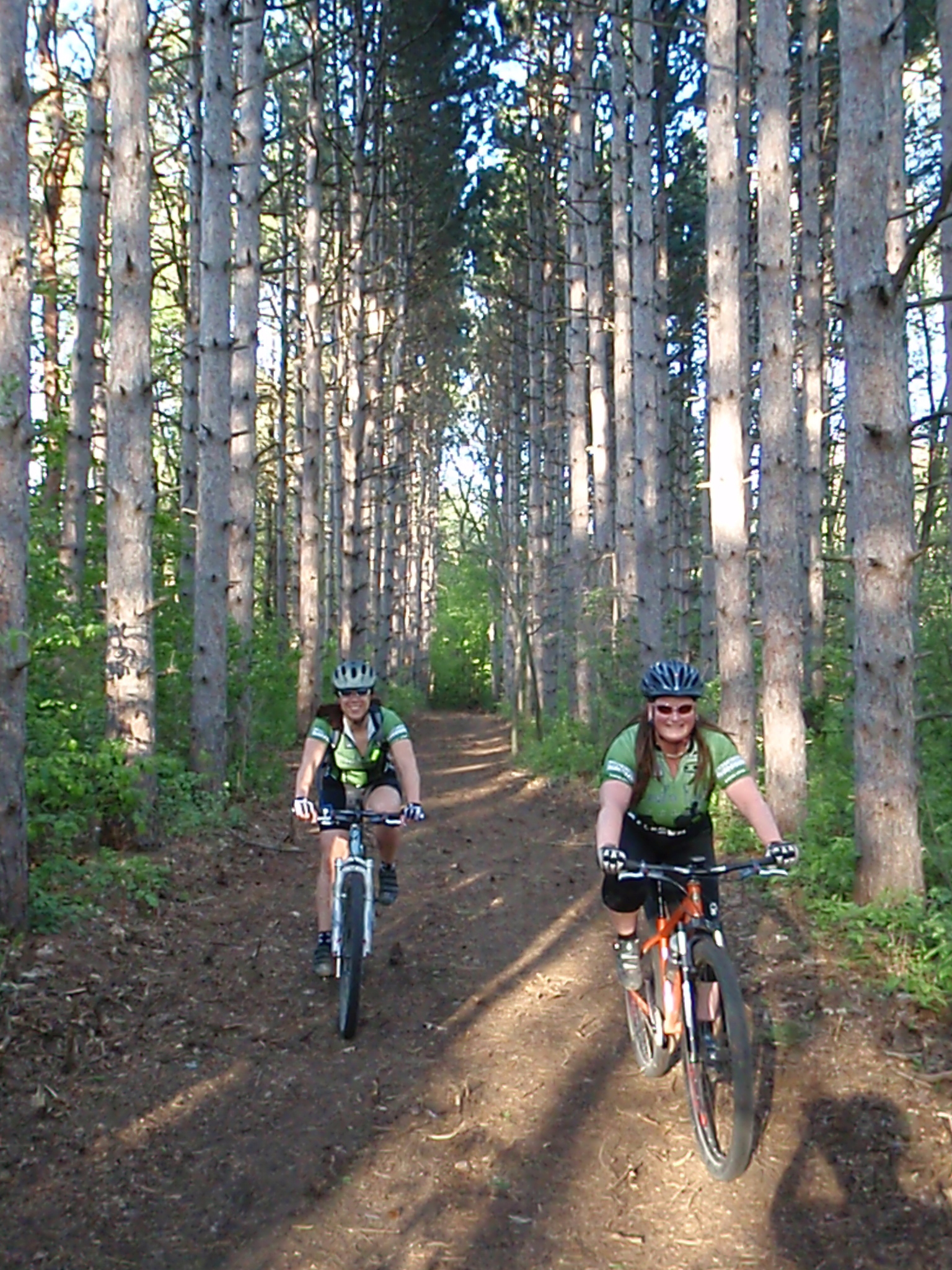 Kristi and Marty riding through some CCC-esque pines in the South Trail portion of the Stony Creek mountain bike trails.