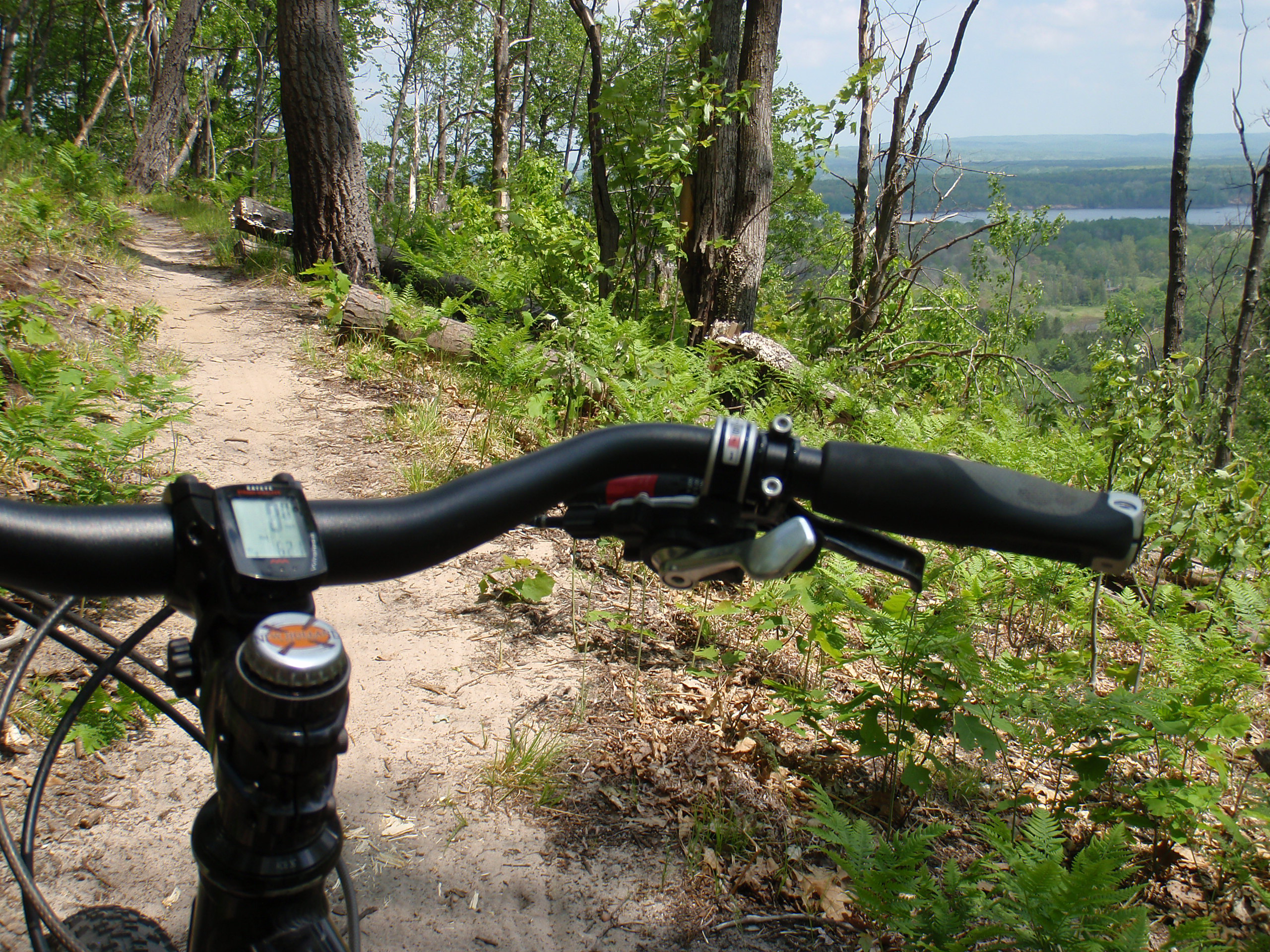 Looking over the handlebars down from the spur of the North Country Trail leading back to the Marilla trailhead.