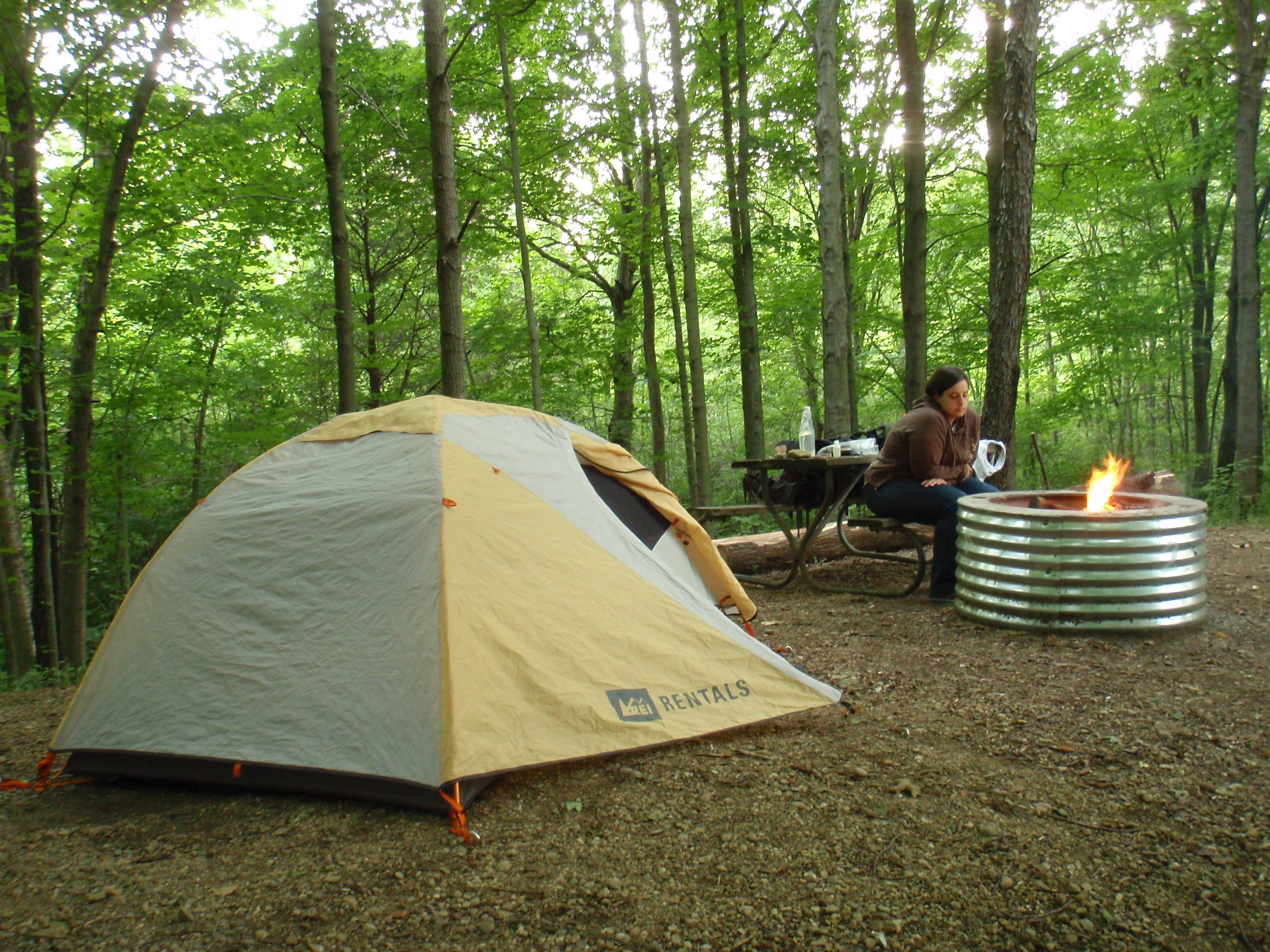 Our rented (from REI) tent, and Danielle sitting by the fire.